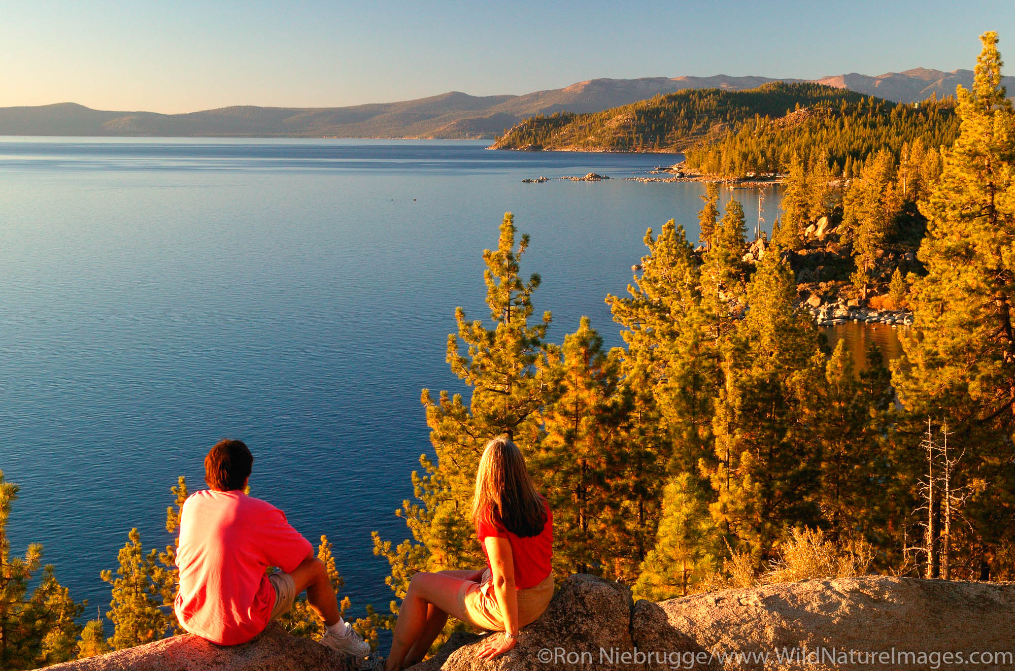Lake Tahoe A couple (MR) enjoys the view of Lake Tahoe from the Nevada side looking towards California, Lake Tahoe.
