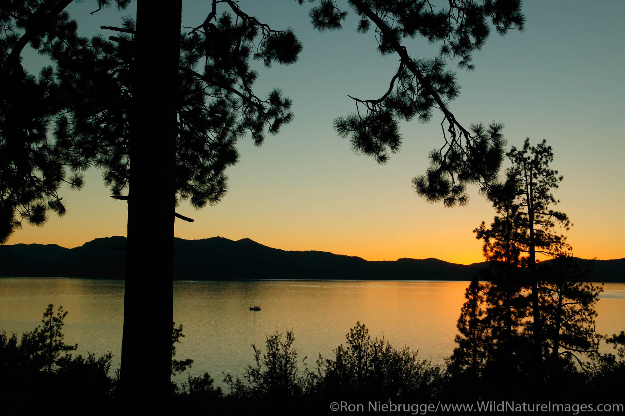 Sailboat on Lake Tahoe at sunset, from Nevada looking towards California.