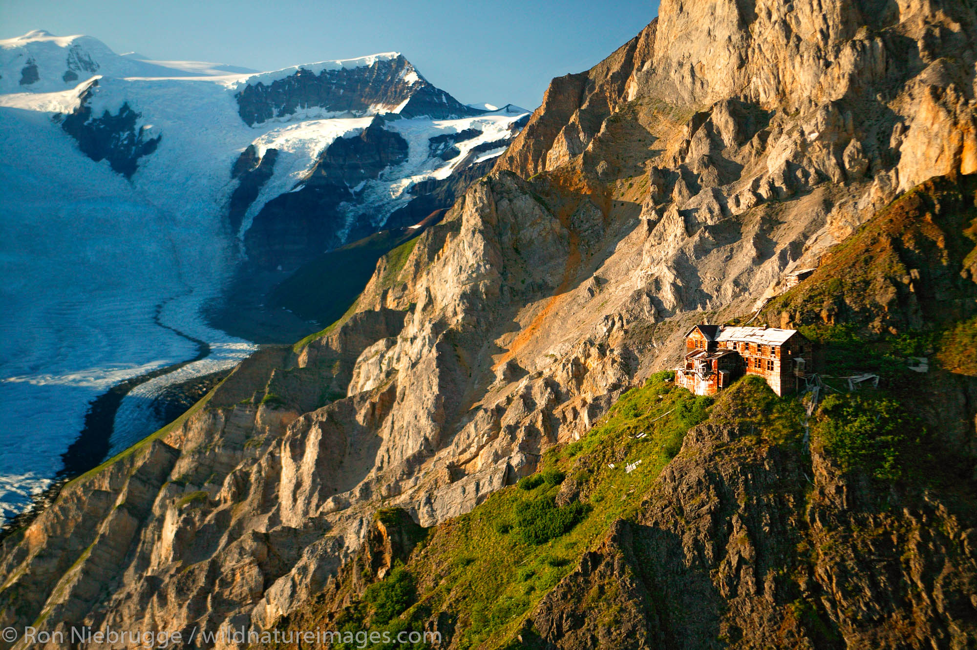 The Erie Mine bunkhouse perched high on the mountains above the Kennicott Copper Mill, the Root Glacier and Stairway Icefall...