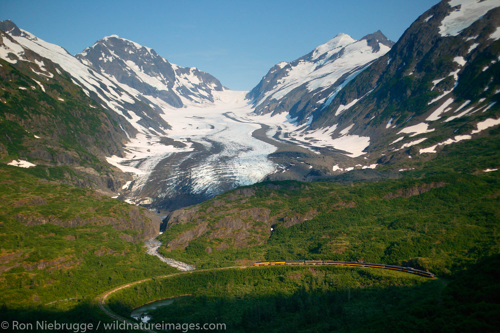 The Alaska Railroad travels through the Chugach National Forest at the "big curve" in front of the Bartlett Glacier, Alaska....