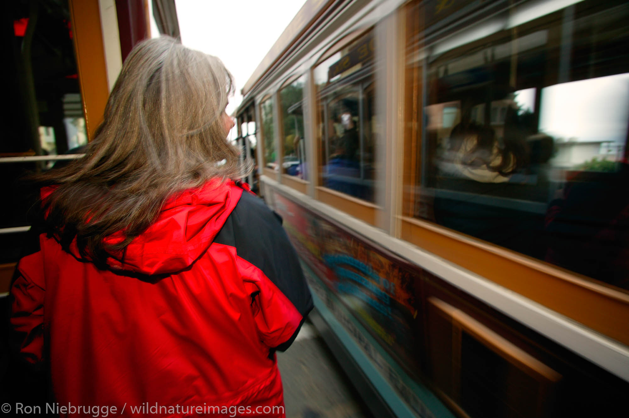 A visitor (mr) riding the Cable Cars in San Francisco, California.