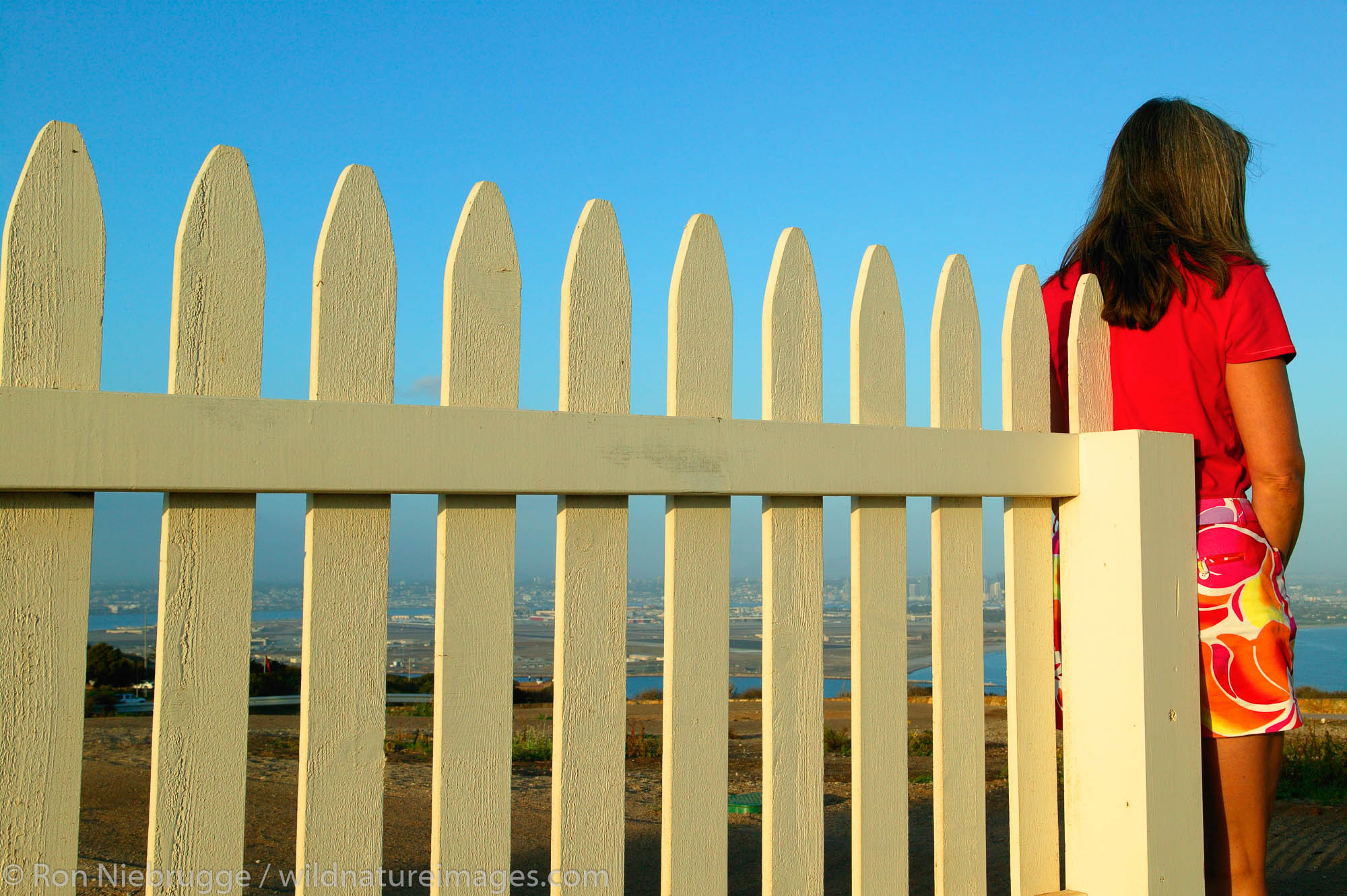 A women (mr) by a picket fence around the Old Point Loma Lighthouse, Cabrillo National Monument, Point Loma, San Diego, California...