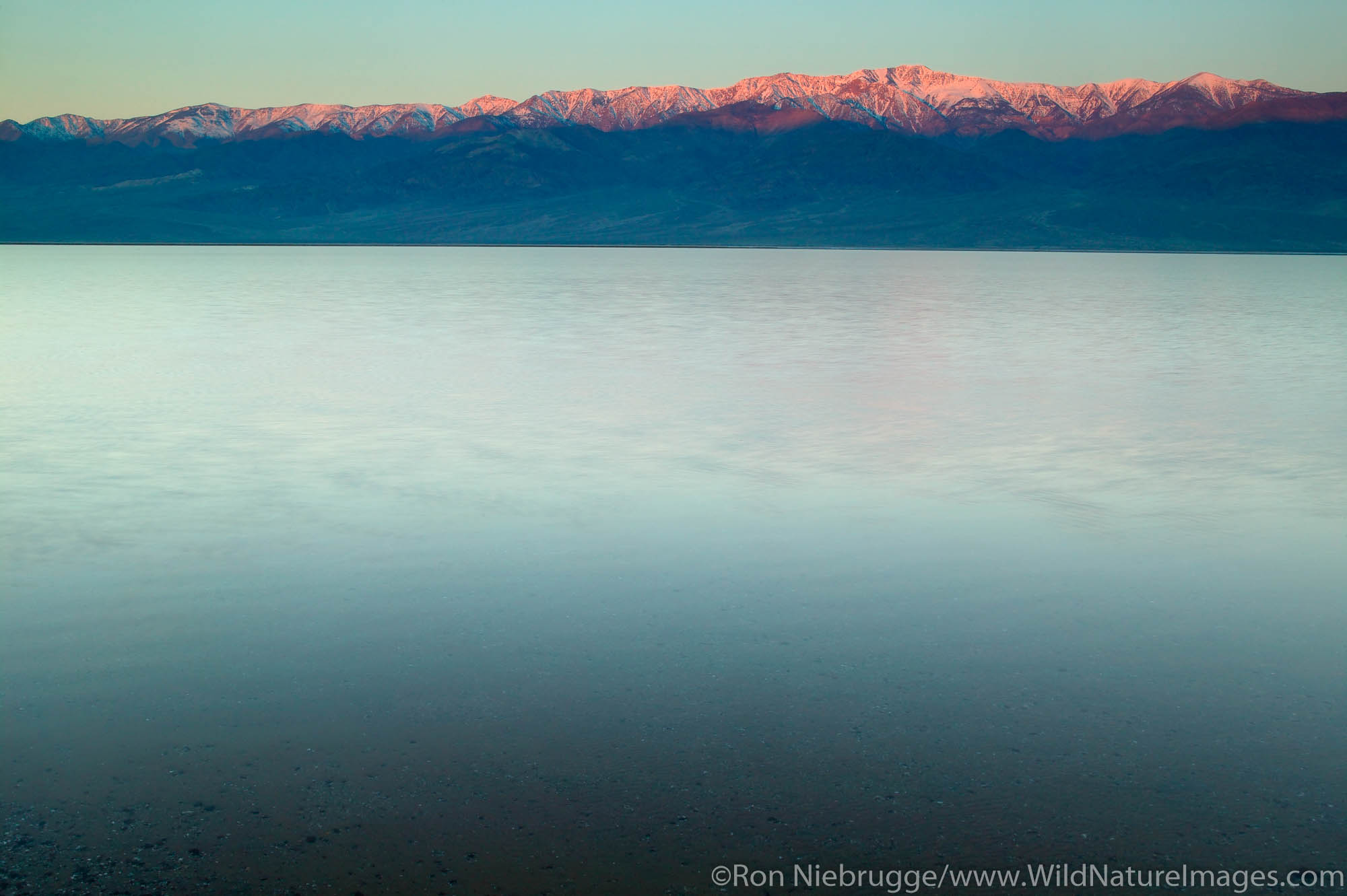 Water from heavy rains fill the Badwater Basin into a lake in 2005.  Death Valley National Park, California.