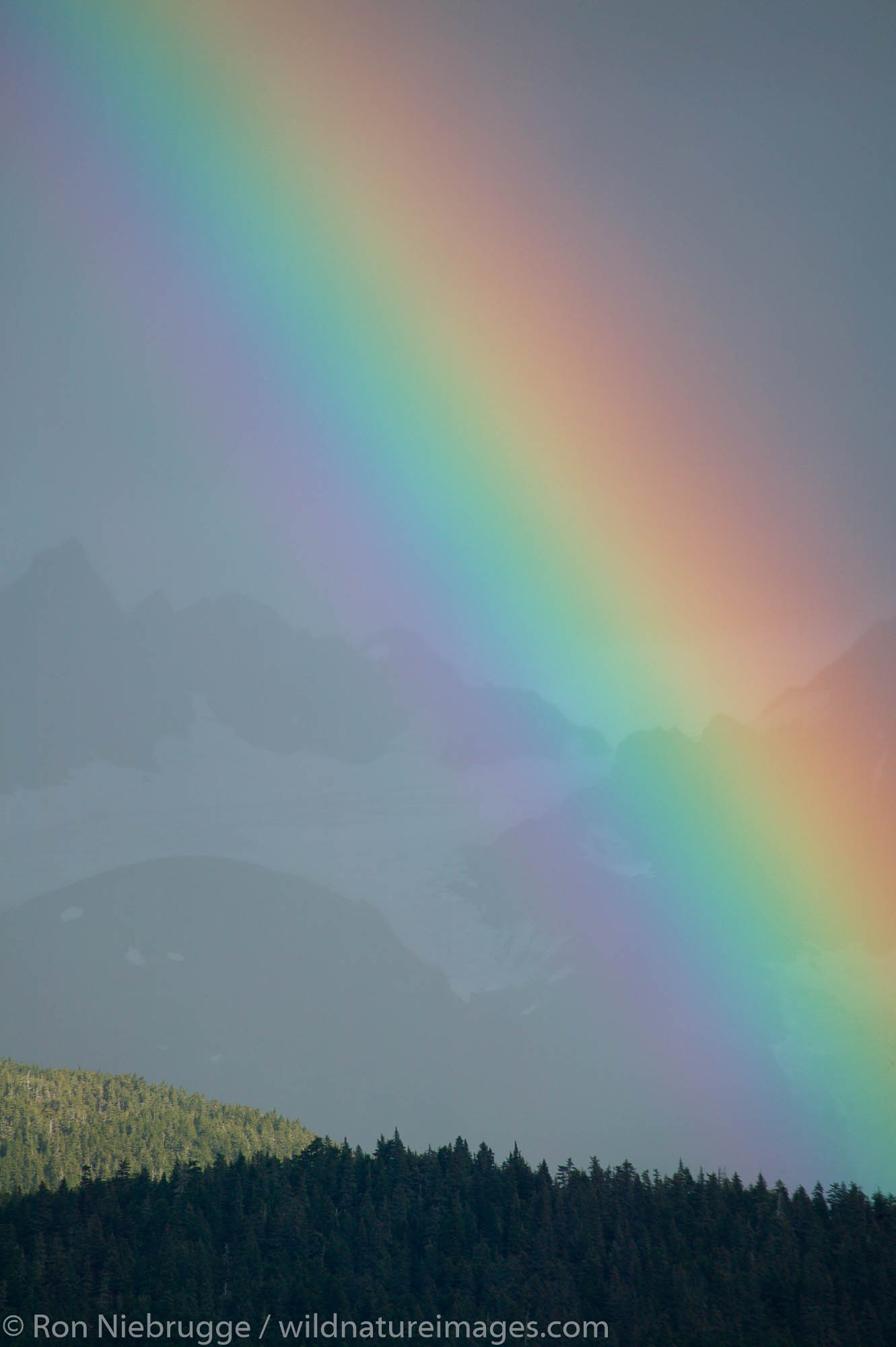 A Rainbow over the mountains of Chugach Natoinal Forest as seen from Seward, Alaska.