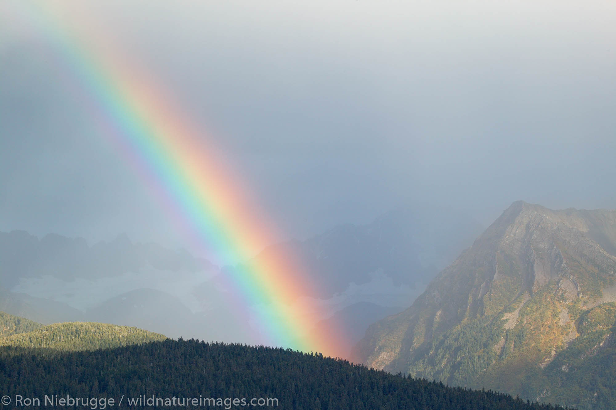 A Rainbow over the mountains of Chugach Natoinal Forest as seen from Seward, Alaska.