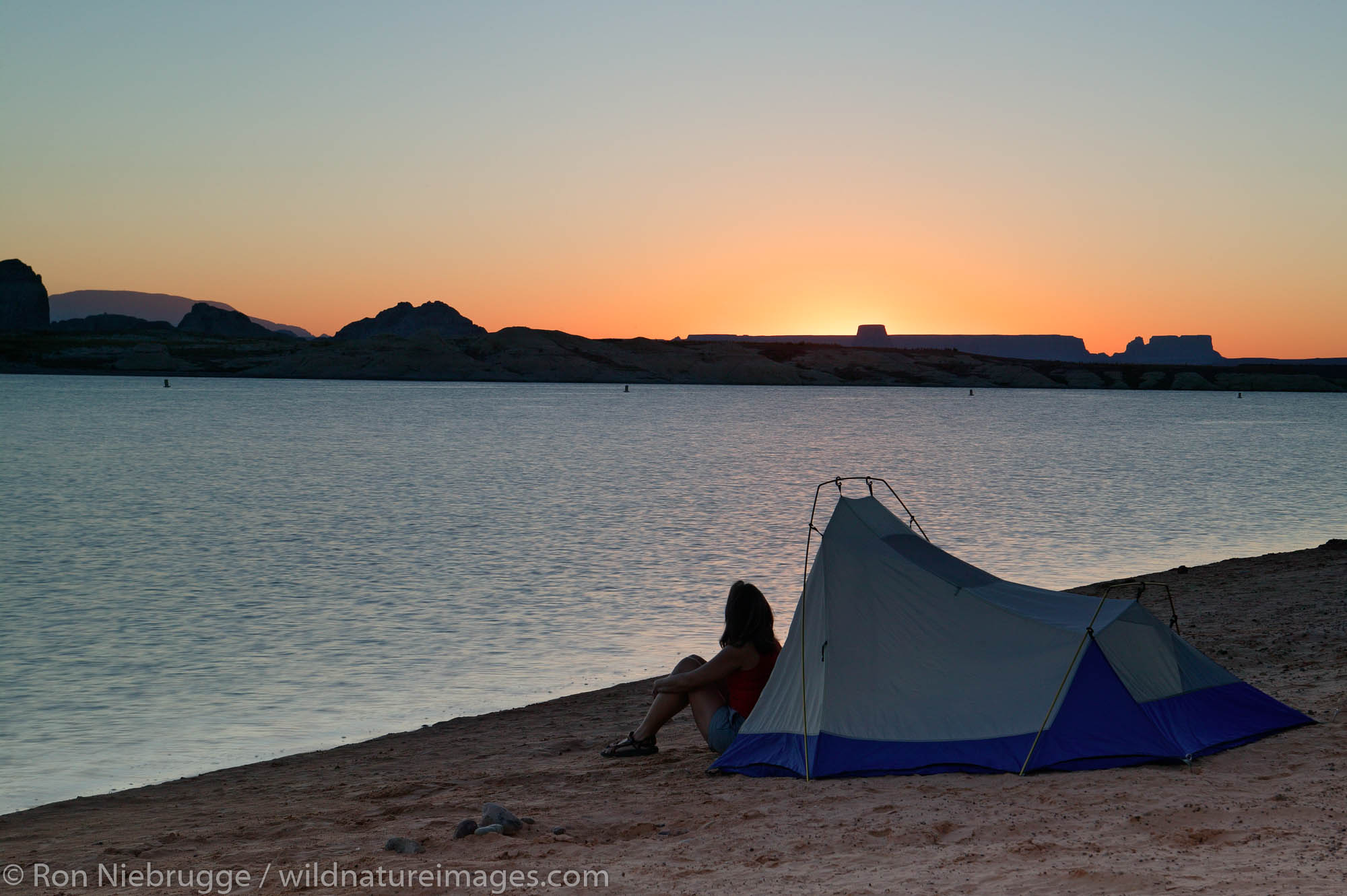Visitors tent camping at the Lone Rock Primitive Campground, Lake Powell and the Glenn Canyon Recreation Area, Utah.  This is...