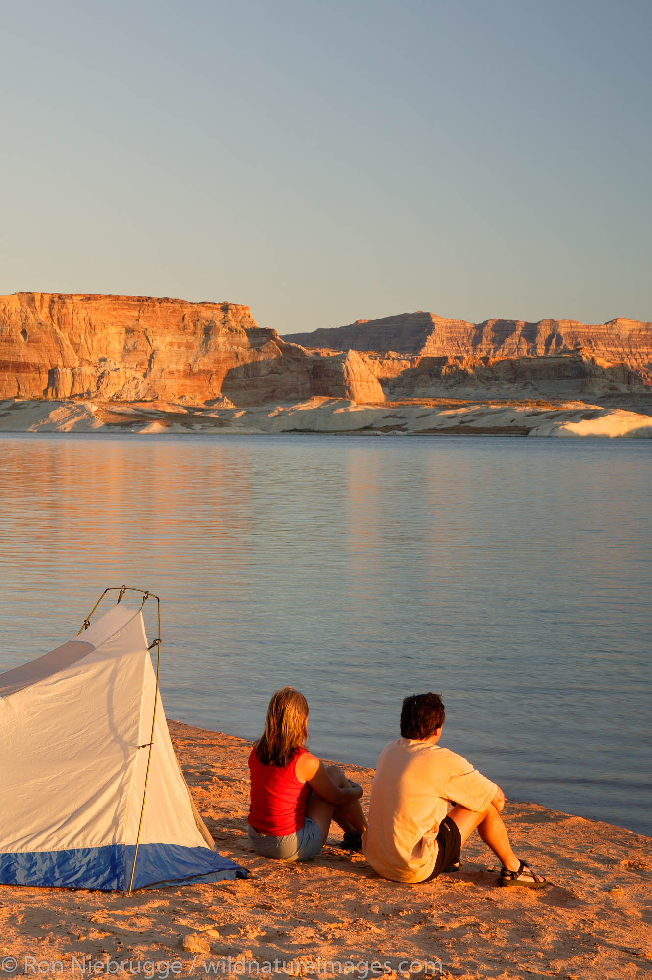 Visitors tent camping at the Lone Rock Primitive Campground, Lake Powell and the Glenn Canyon Recreation Area, Utah.  This is...