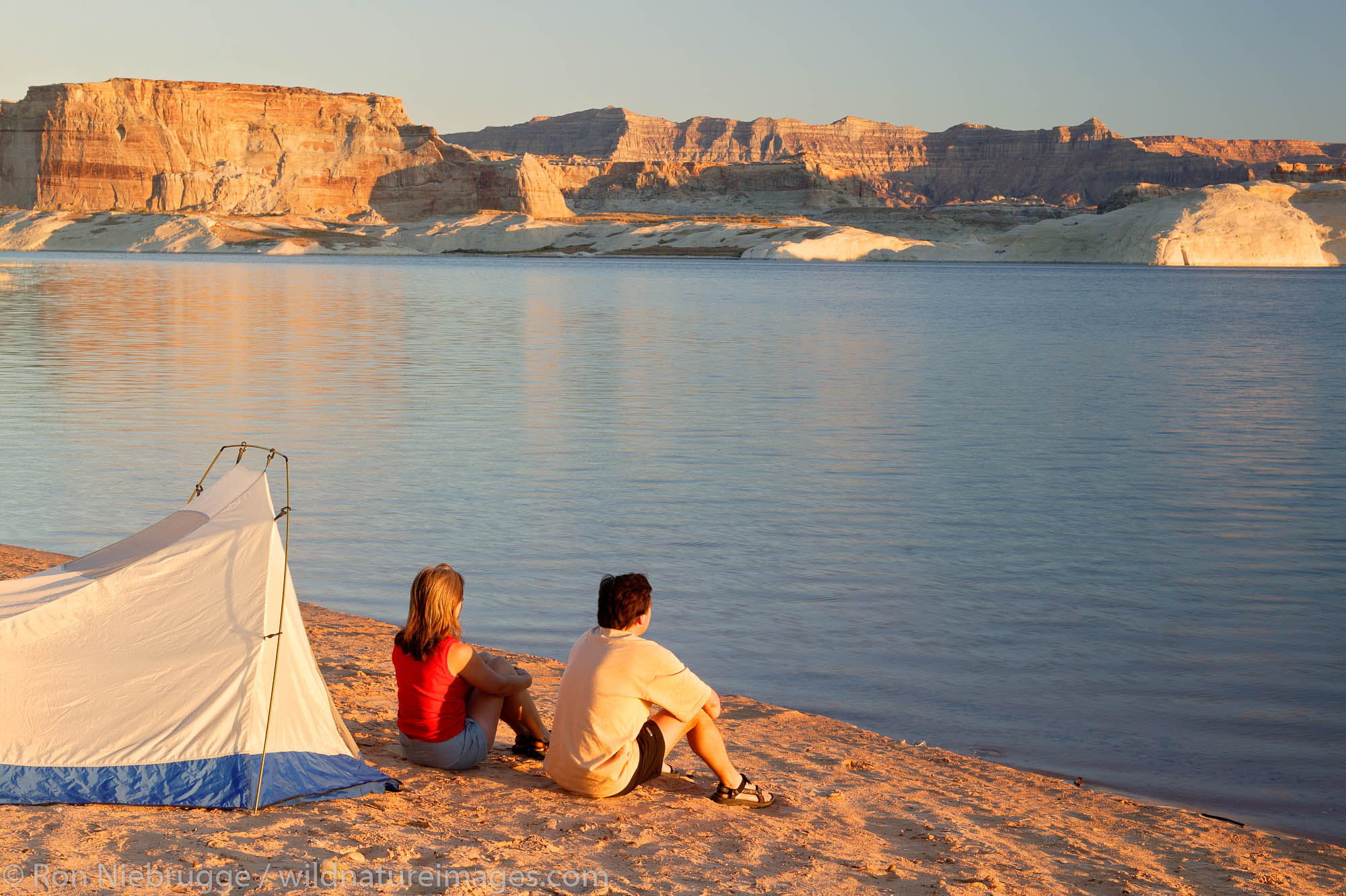 Visitors tent camping at the Lone Rock Primitive Campground, Lake Powell and the Glenn Canyon Recreation Area, Utah.  This is...