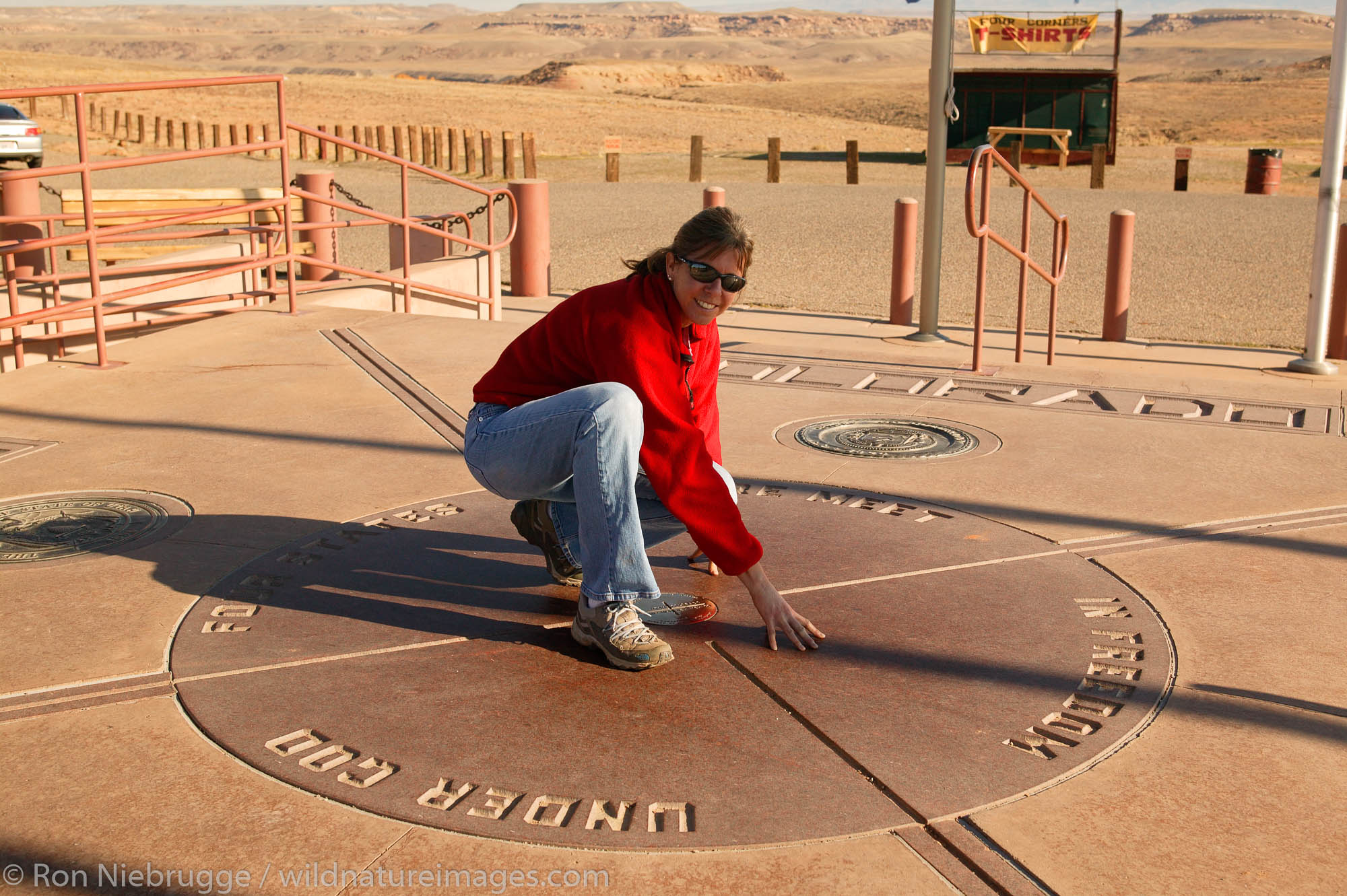 A visitor in four states at once at Four Corners, the point where Colorado, Arizona, New Mexico and Utah state lines all meet...