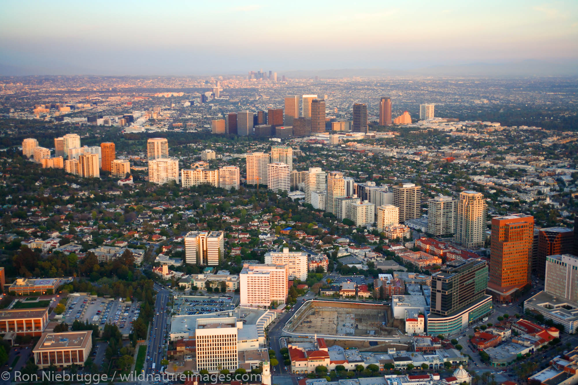 Aerial view of Beverly Hills with Wilshire Blvd in the foreground and Santa Monica Blvd, Los Angeles, California.