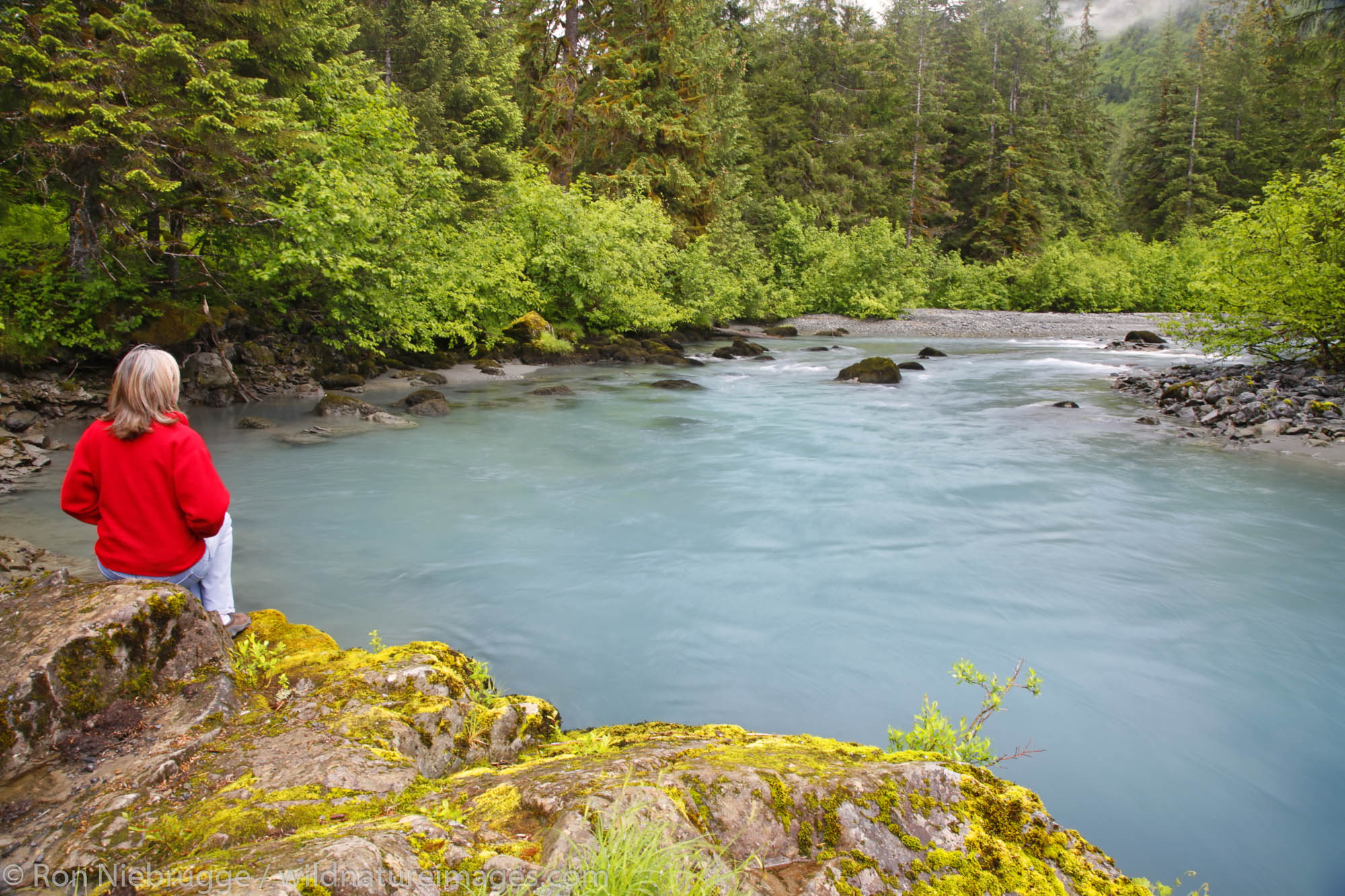 A visitor enjoys Power Creek, Cordova, Chugach National Forest, Alaska. (MR)