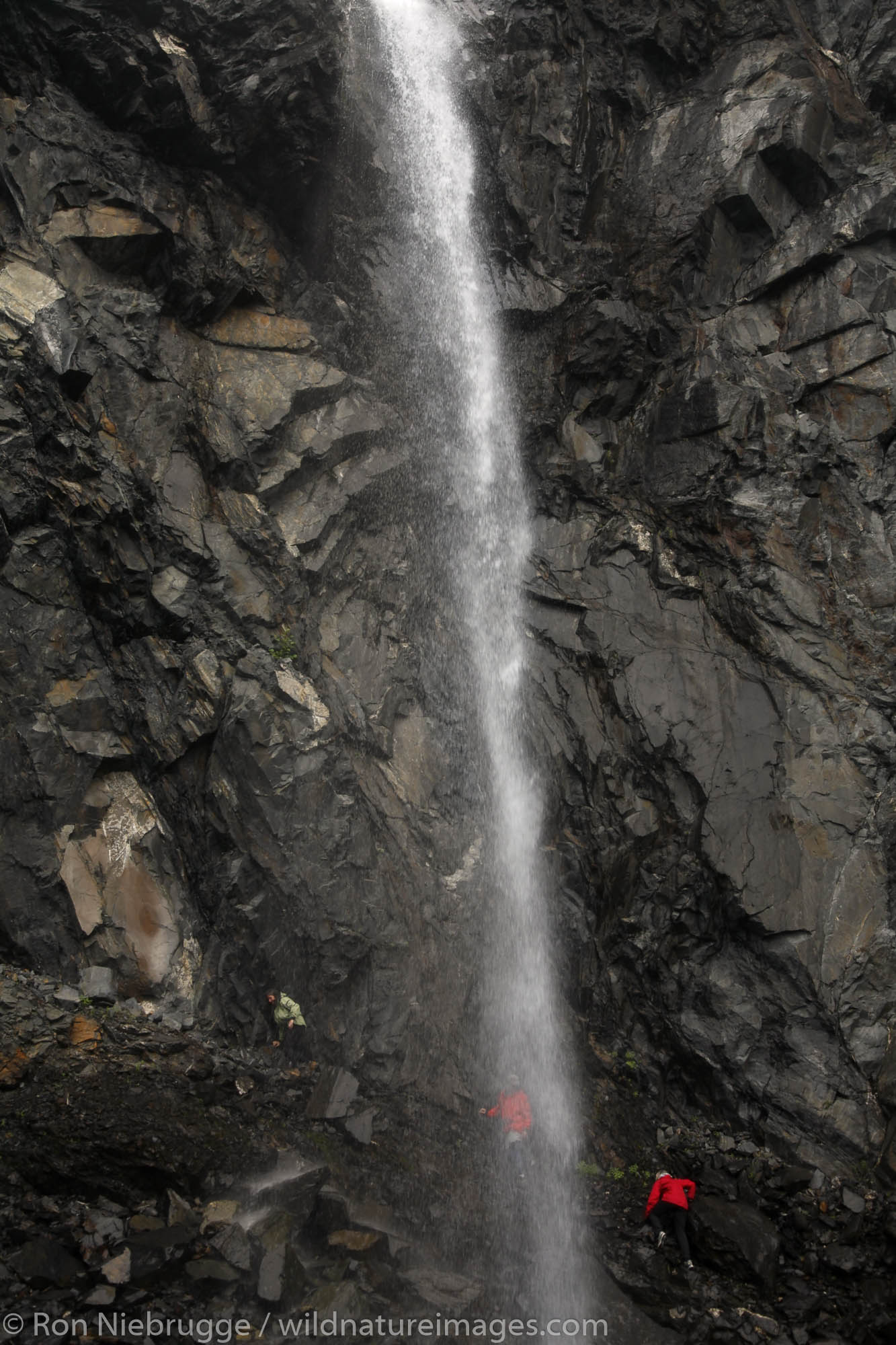 Hikers at waterfalls below Cataract Glacier, Harriman Fiord, Prince William Sound, Chugach National Forest, Alaska. (MR)