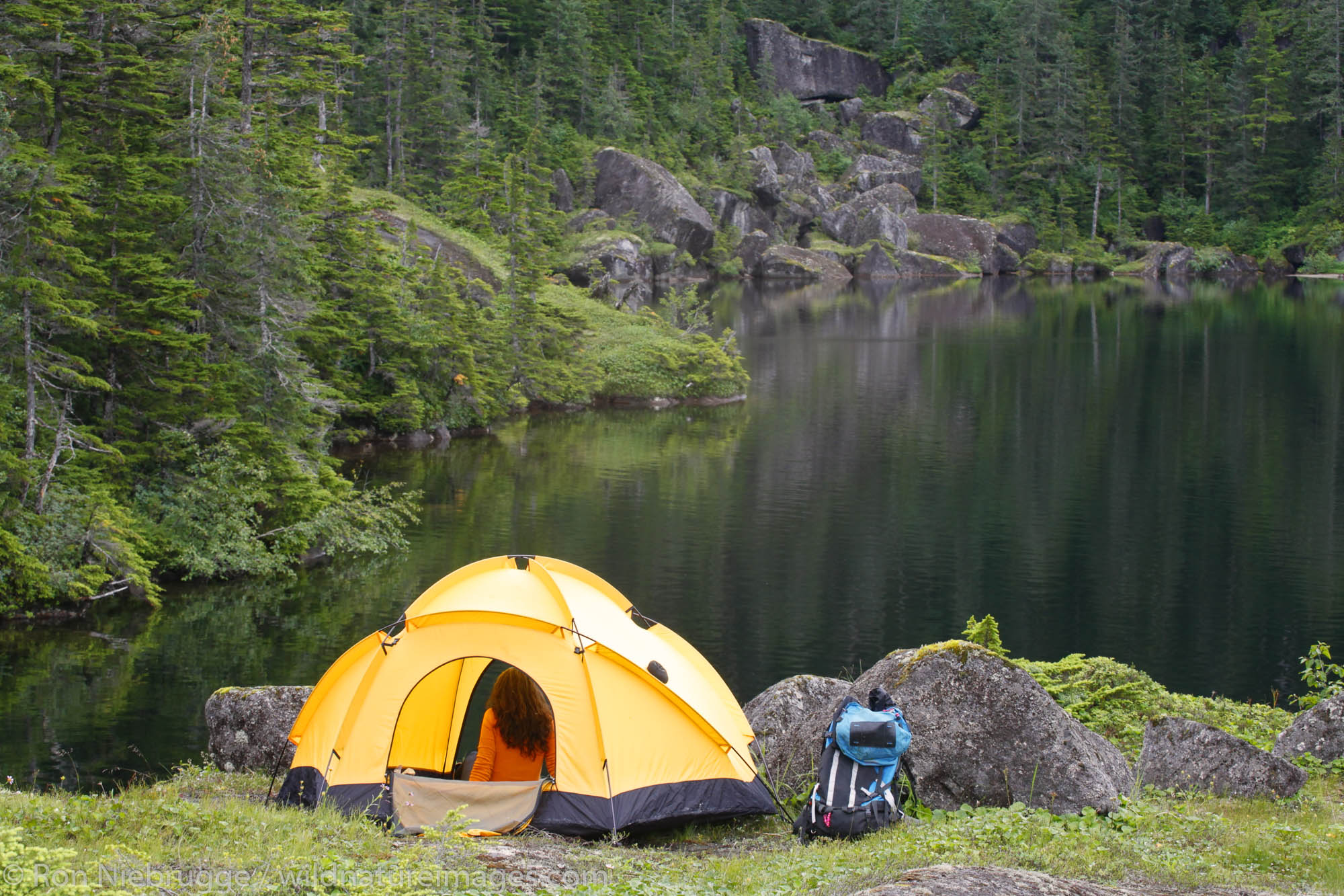 A female backpacker camping on Culross Island, Prince William Sound, Chugach National Forest, Alaska. (MR)