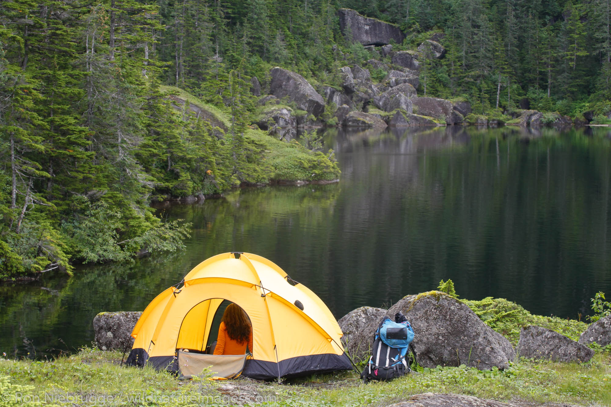 A female backpacker camping on Culross Island, Prince William Sound, Chugac...