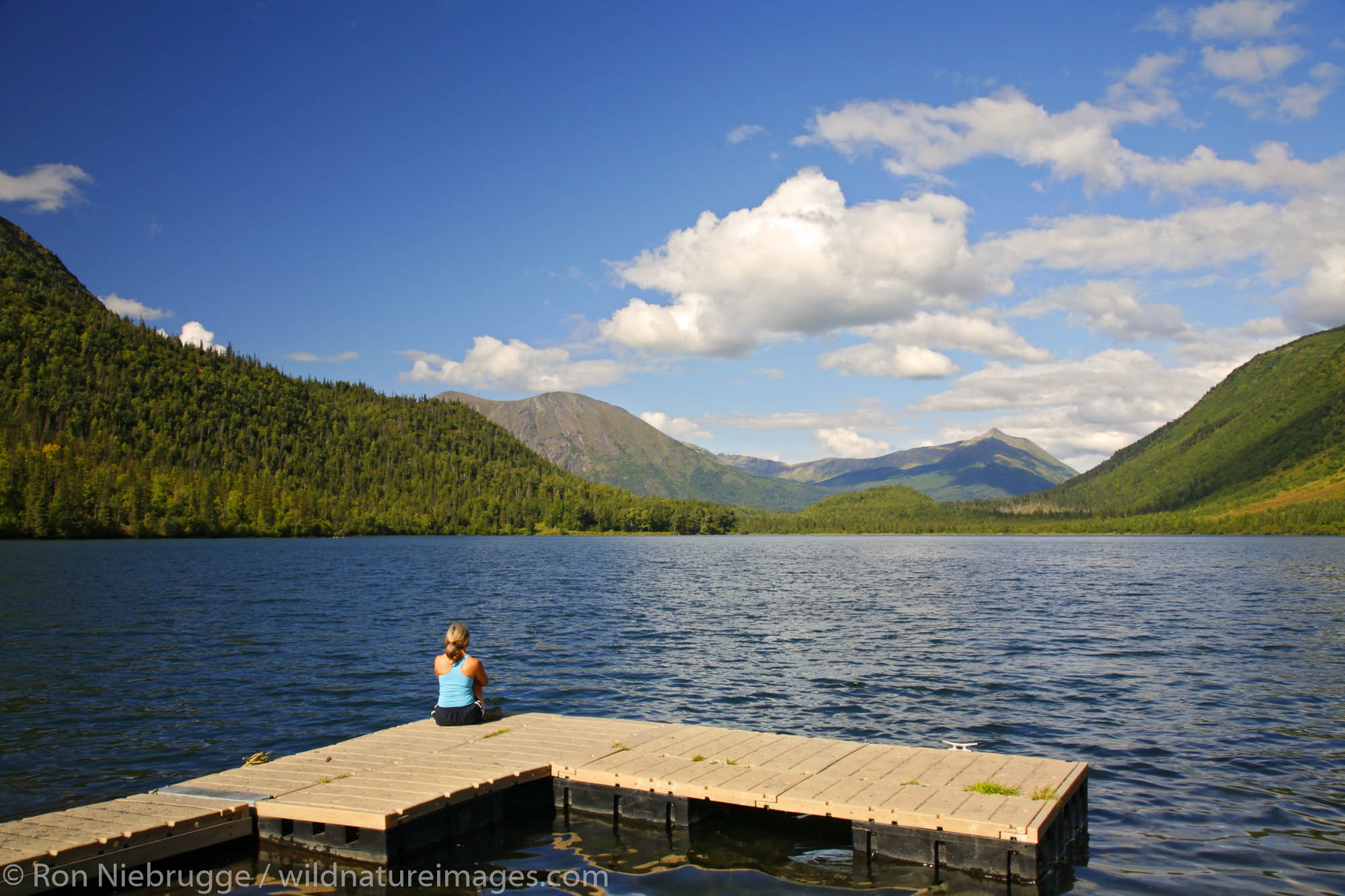 A visitor on the dock at Lower Russian Lake, Russian Lakes-Resurrection River Trail, Kenai Peninsula, Chugach National Forest...