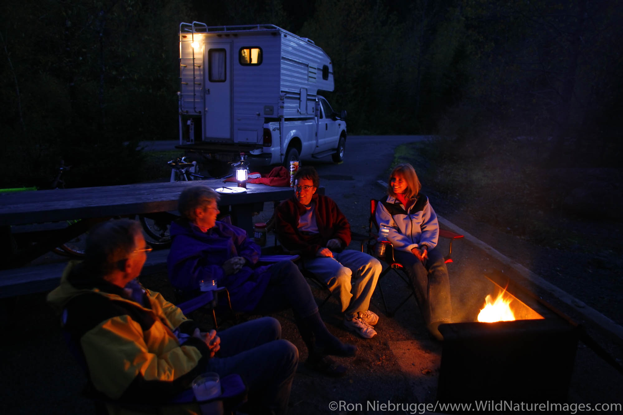 Sitting around the campfire at the Williwaw Campground, Portage Valley, Chugach National Forest, Alaska. (MR)