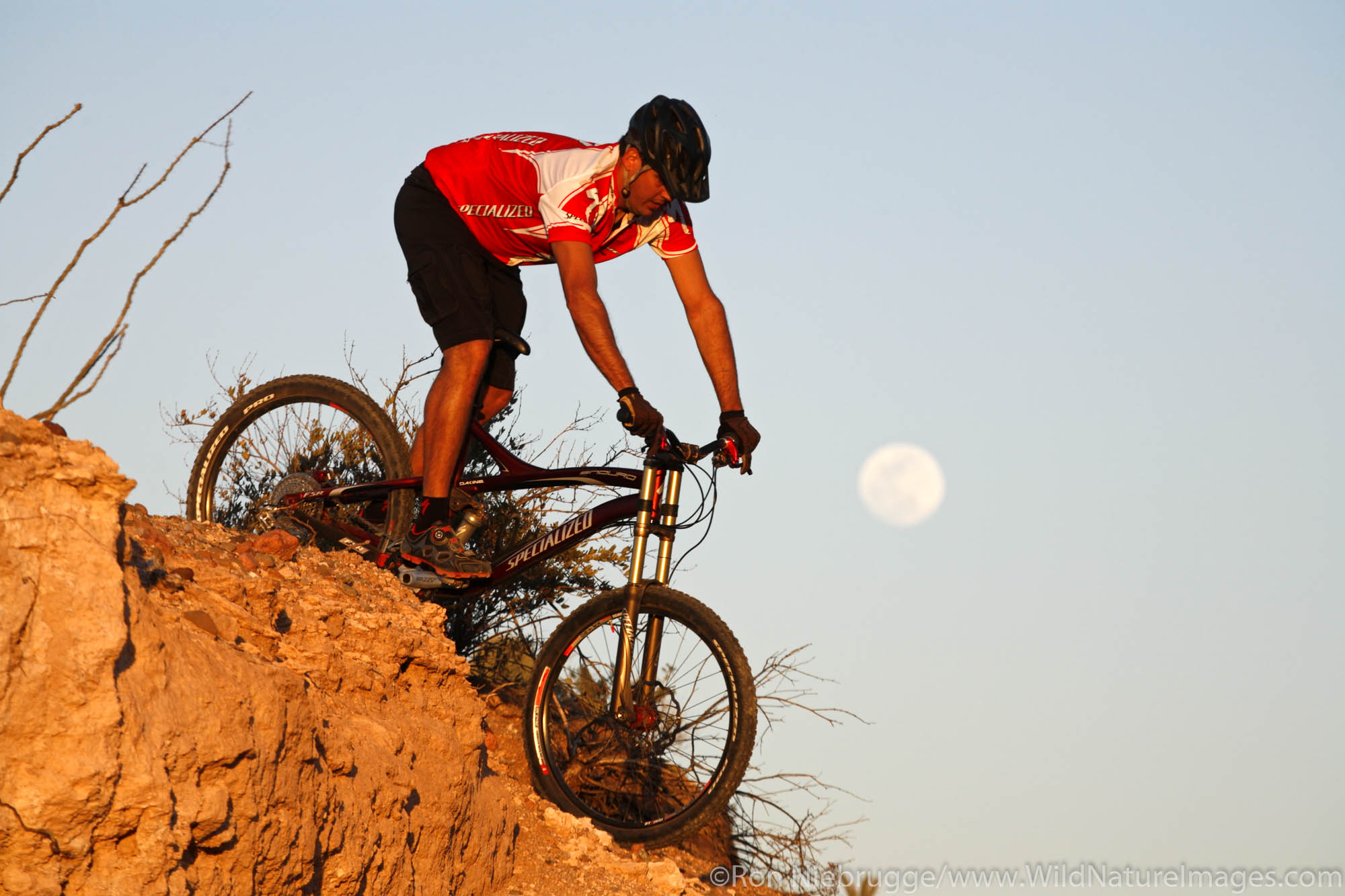 A mountain biker and a full moon at McDowell Mountain Regional Park near Phoenix, Ariziona. (Model Released)
