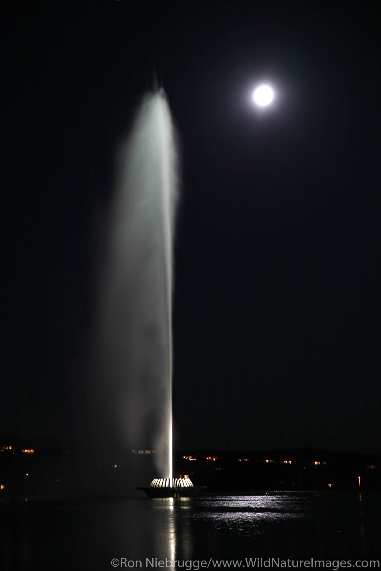 The fountain in Fountain Hills at night under a full moon, near Phoenix, Arizona.