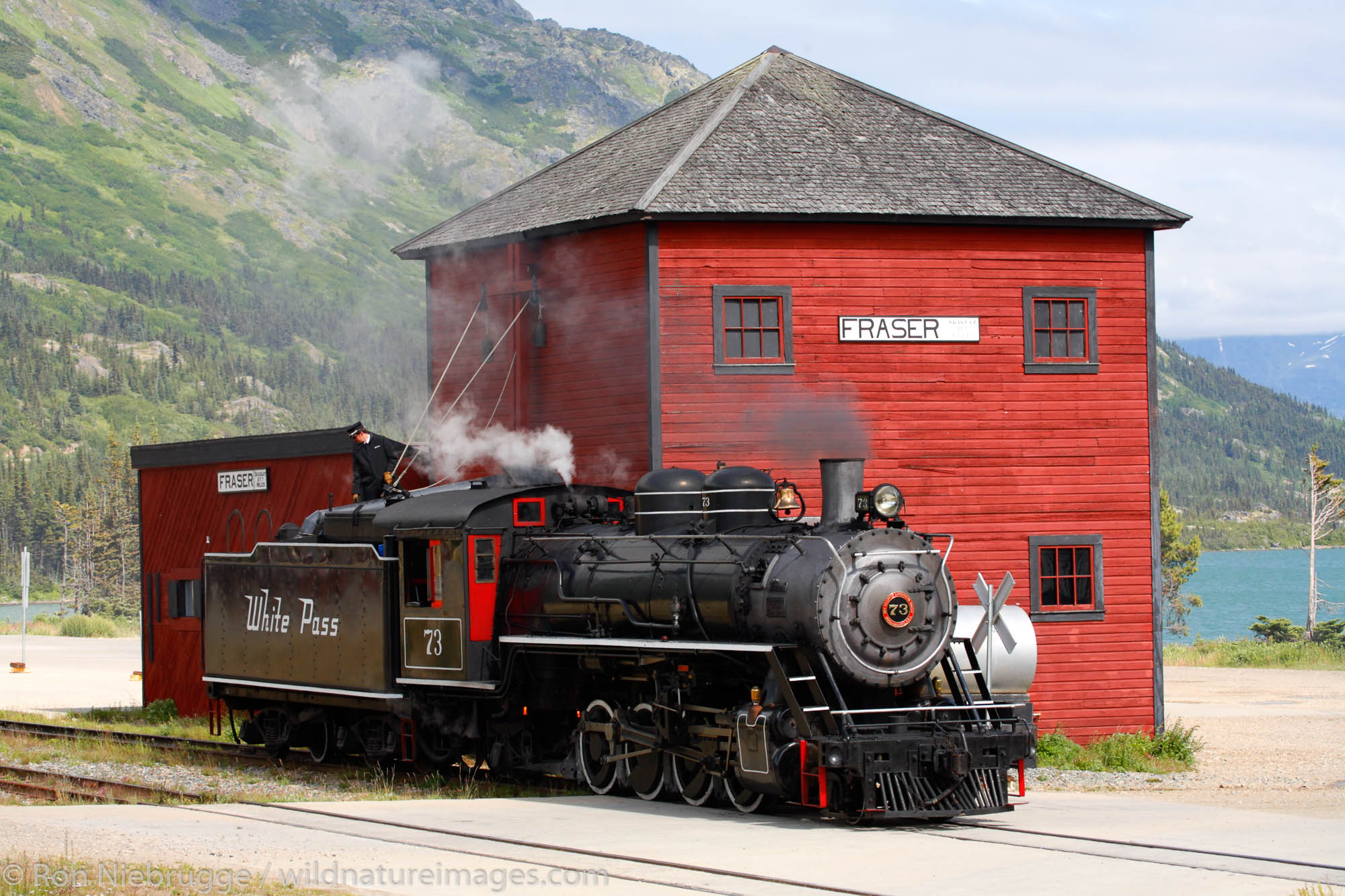 The historic steam engine number 73 gets water in Fraser, British Columbia Canada as part of the White Pass and Yukon Route railroad...