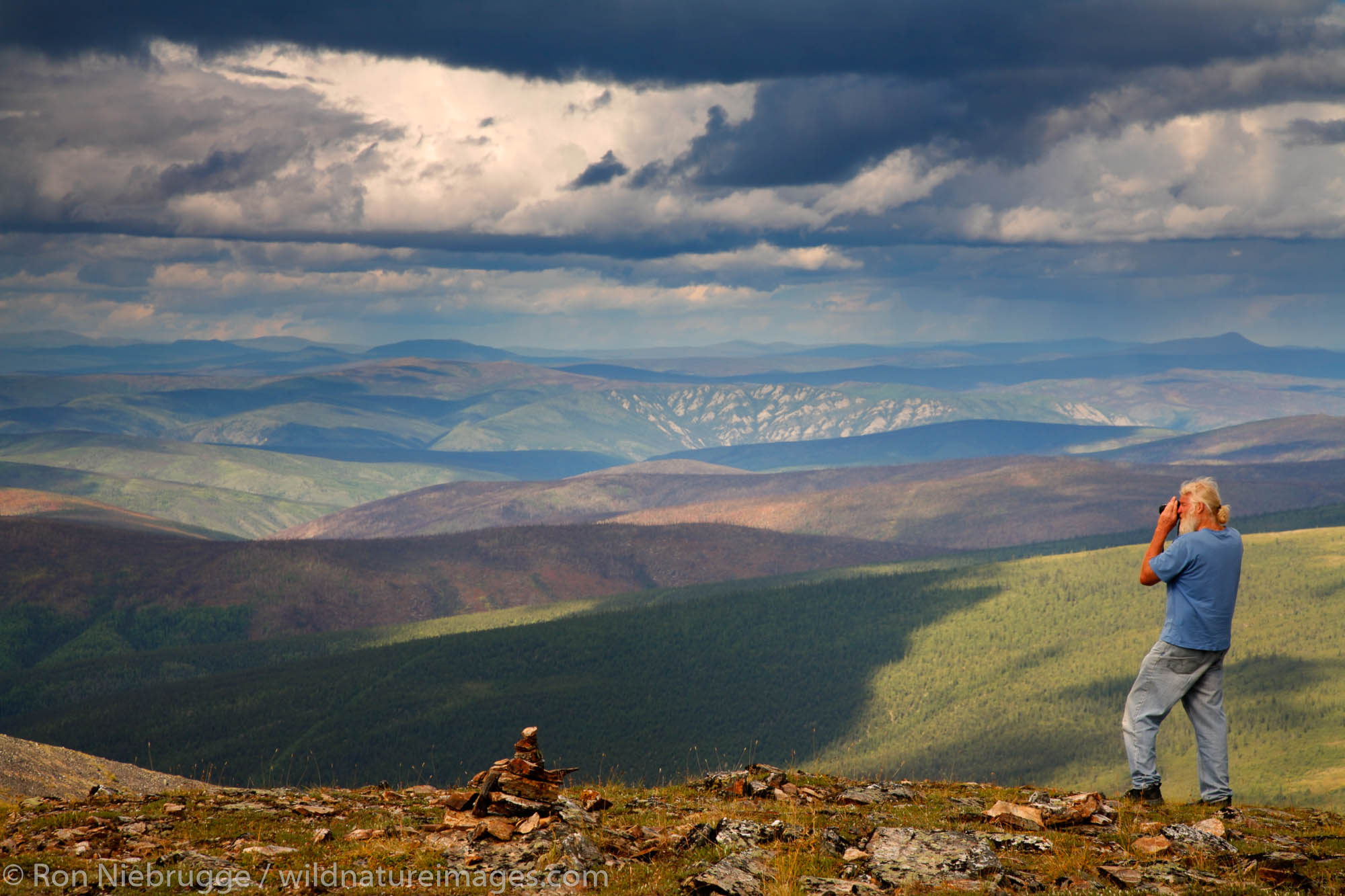 A visitor enjoys the view from along the Top of the World Highway, Yukon Territory, Canada.