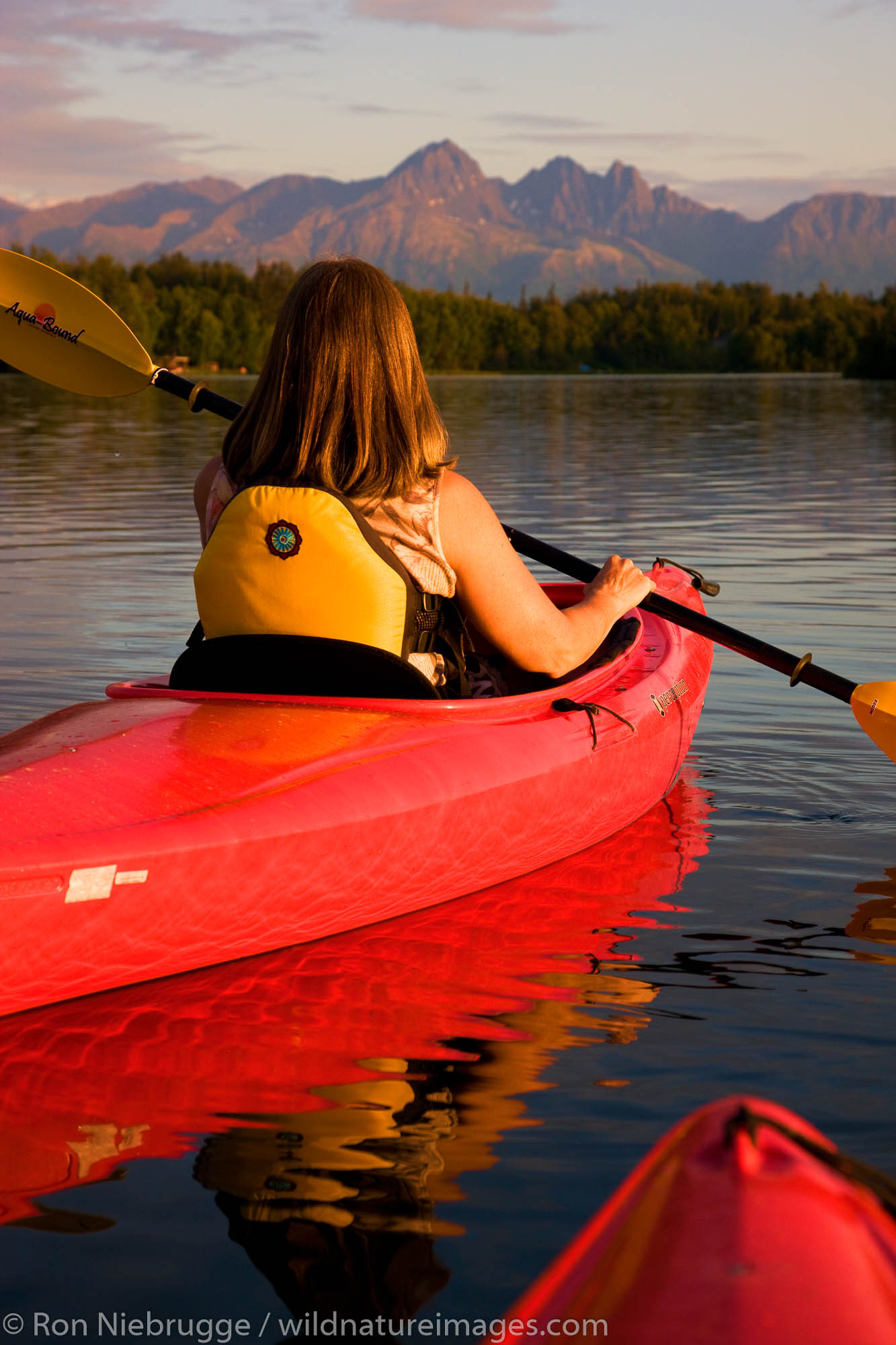 Kayaking on Finger Lake, Wasilla, Alaska.  (model released)