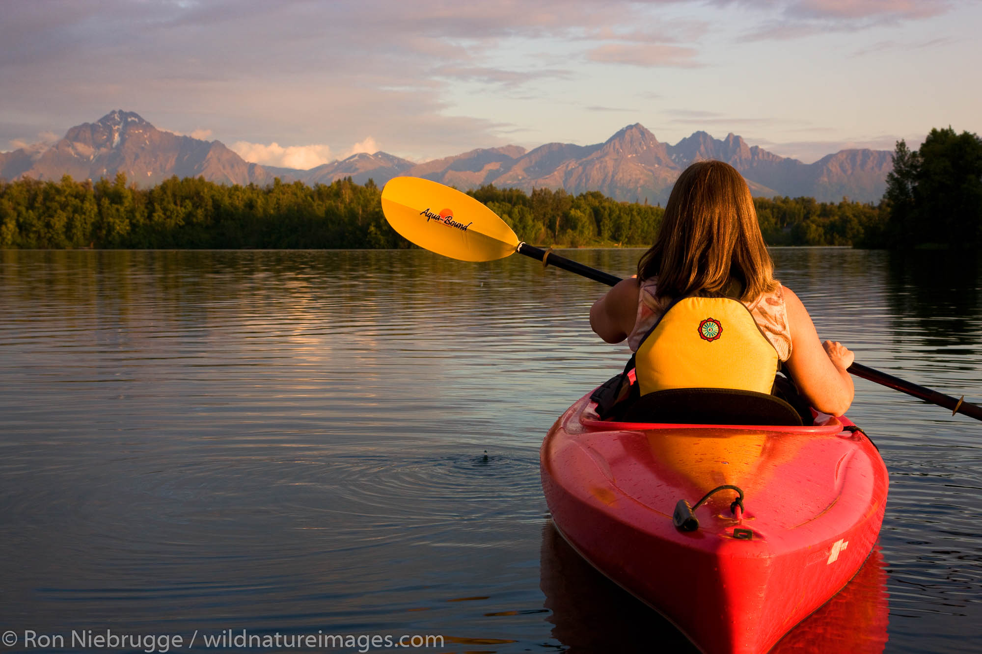 Kayaking on Finger Lake, Wasilla, Alaska.  (model released)