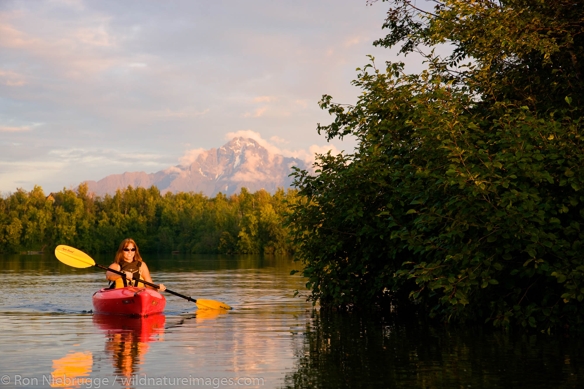 Kayaking on Finger Lake, Wasilla, Alaska.  (model released)