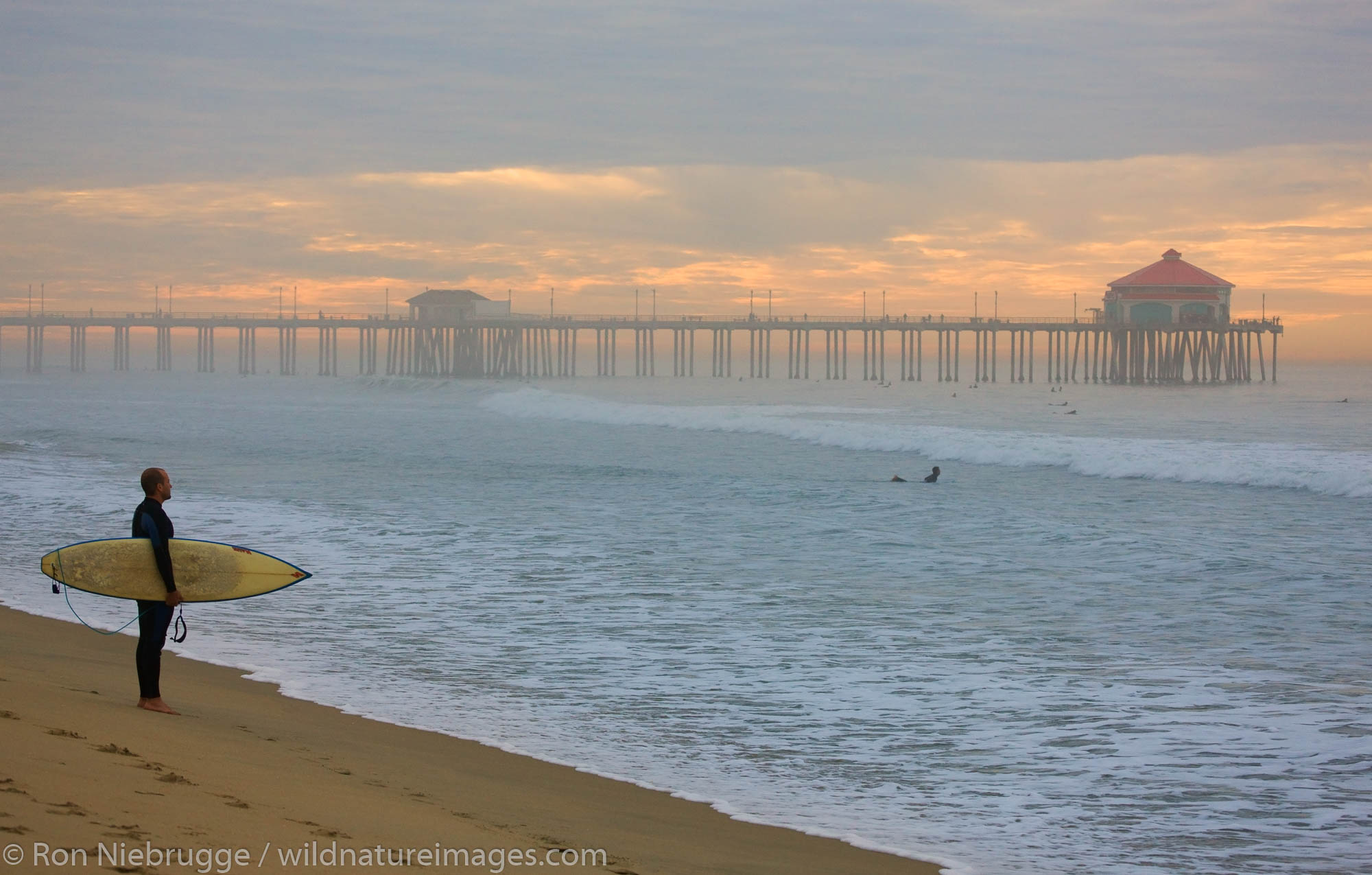 Surfers near the pier, Huntington Beach, Orange County, California.