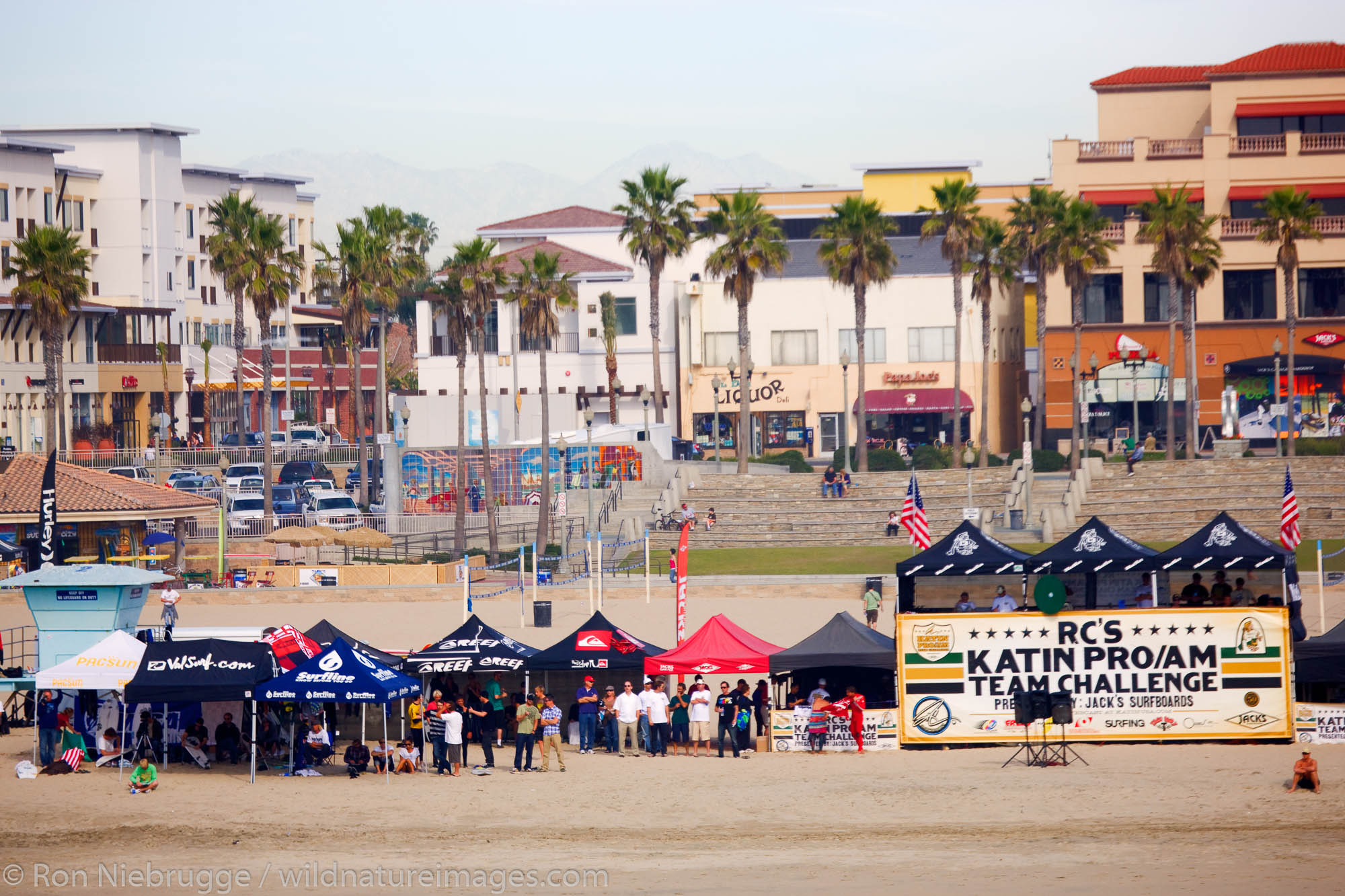 Surfers competing in the Katin Pro/Am surf competition at Huntington Beach Pier, Orange County, California.