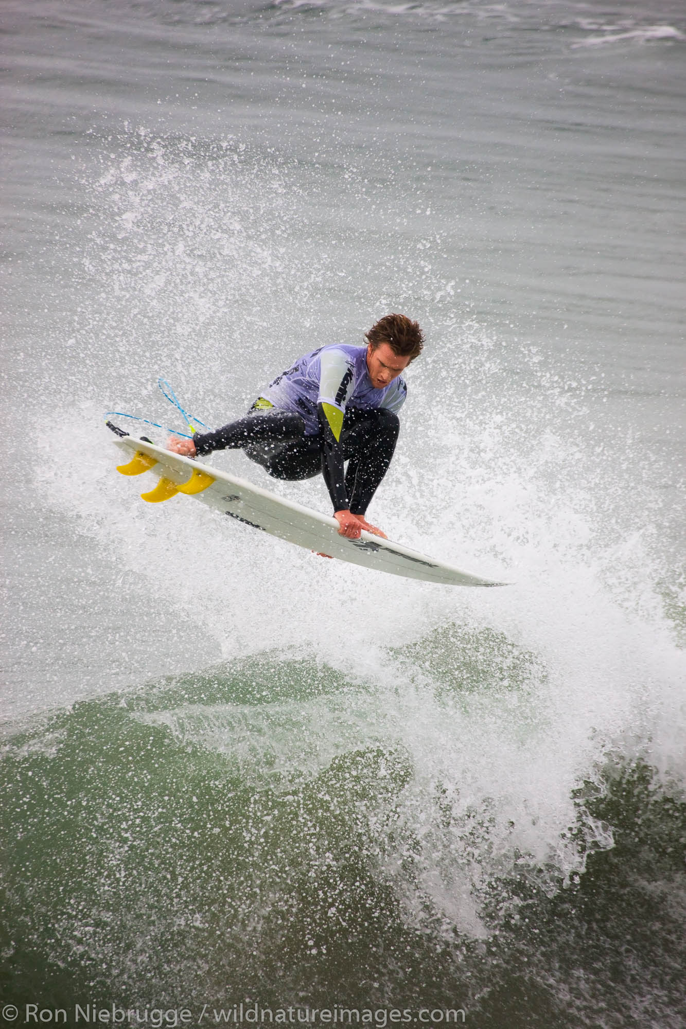 Brett Simpson competing in the Katin Pro/Am surf competition at Huntington Beach Pier, Orange County, California.