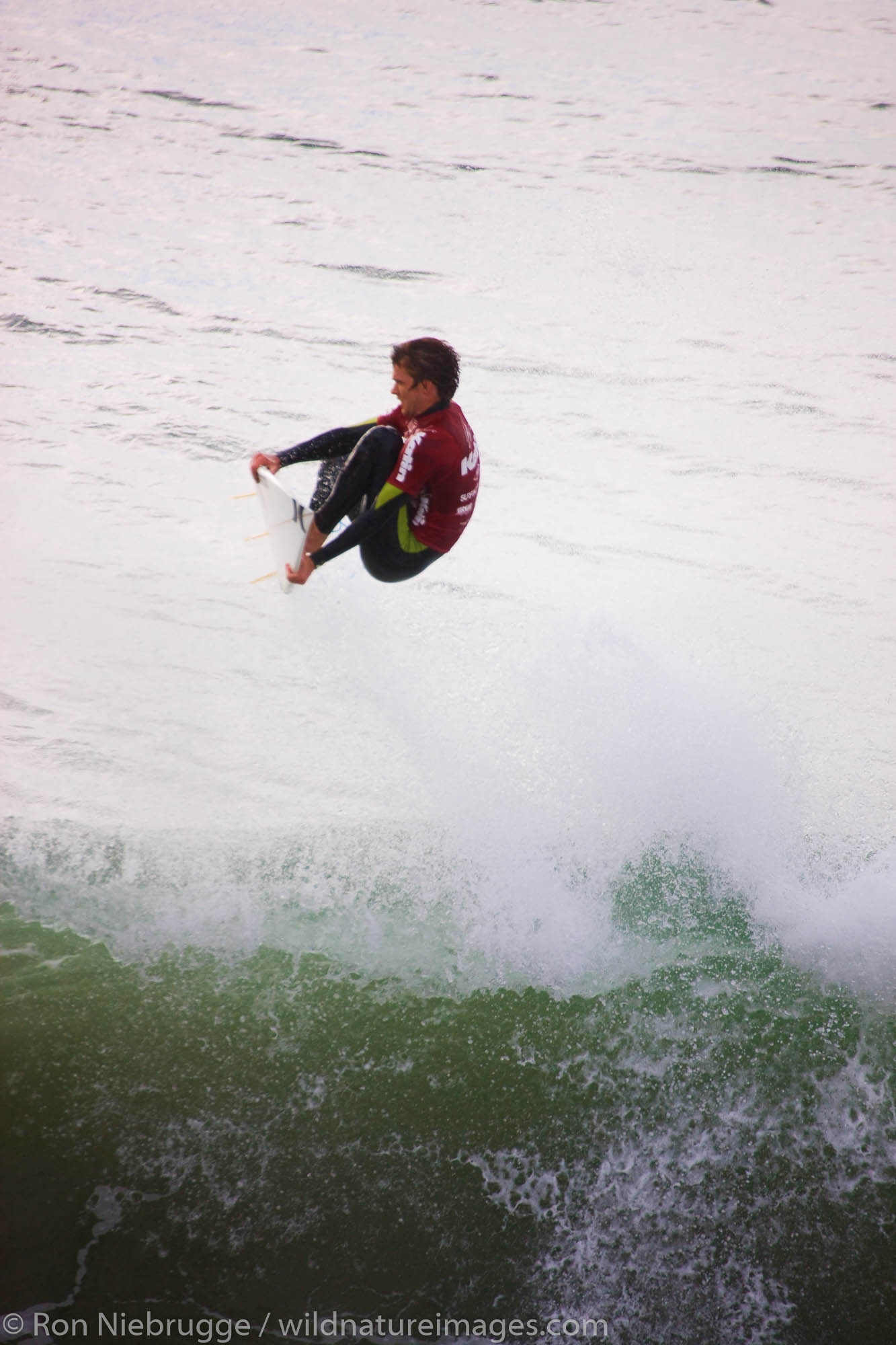 Brett Simpson competing in the Katin Pro/Am surf competition at Huntington Beach Pier, Orange County, California.