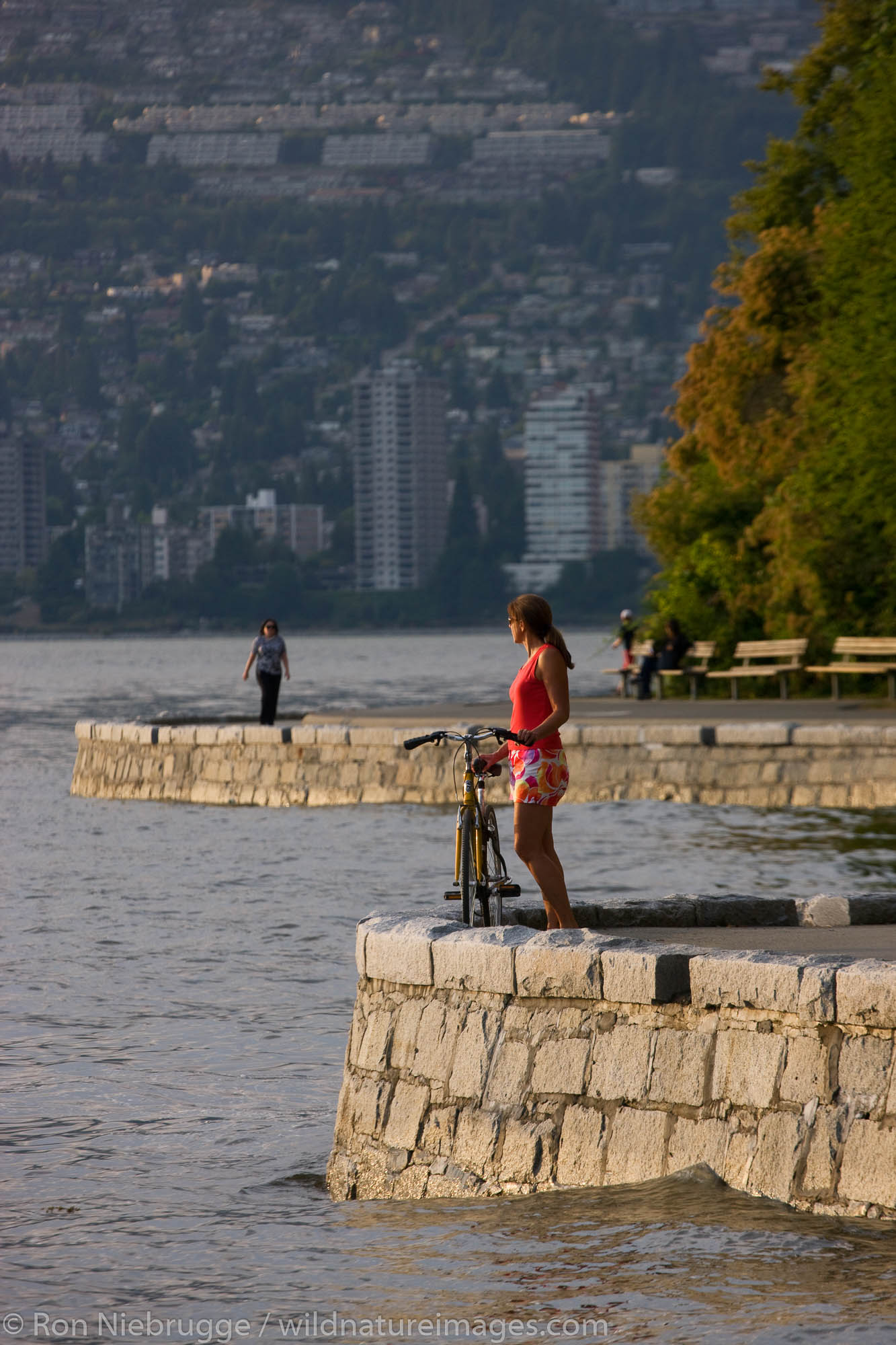 Bike riding on the coastal trail in Stanley Park, Vancouver, British Columbia, Canada.  (model released)