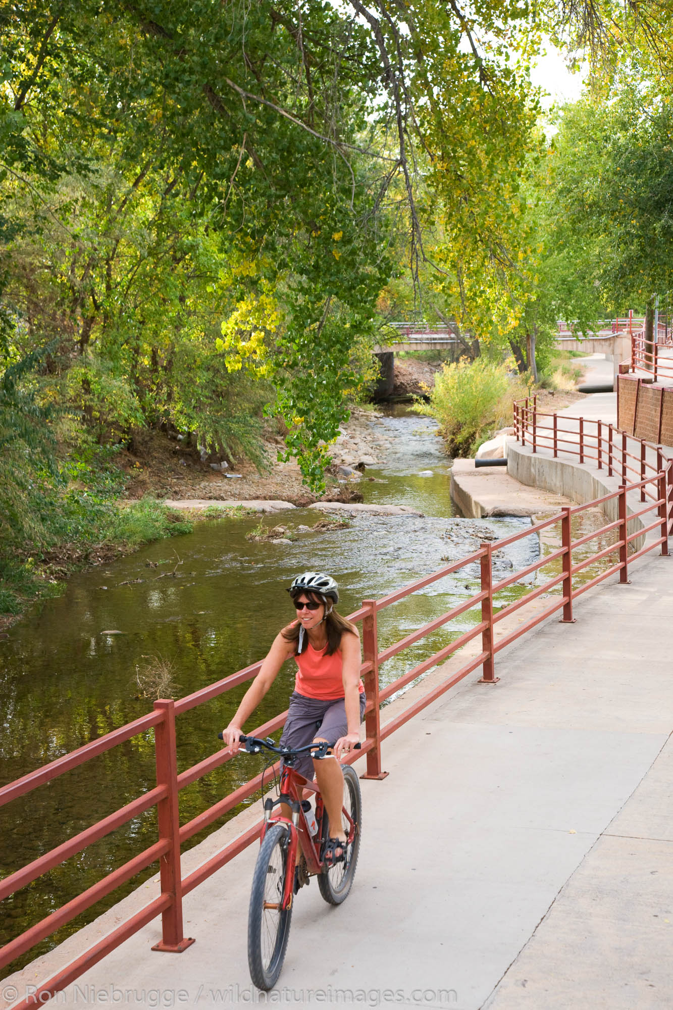A visitor rides on a bike trail through downtown Moab, Utah.  (model released)