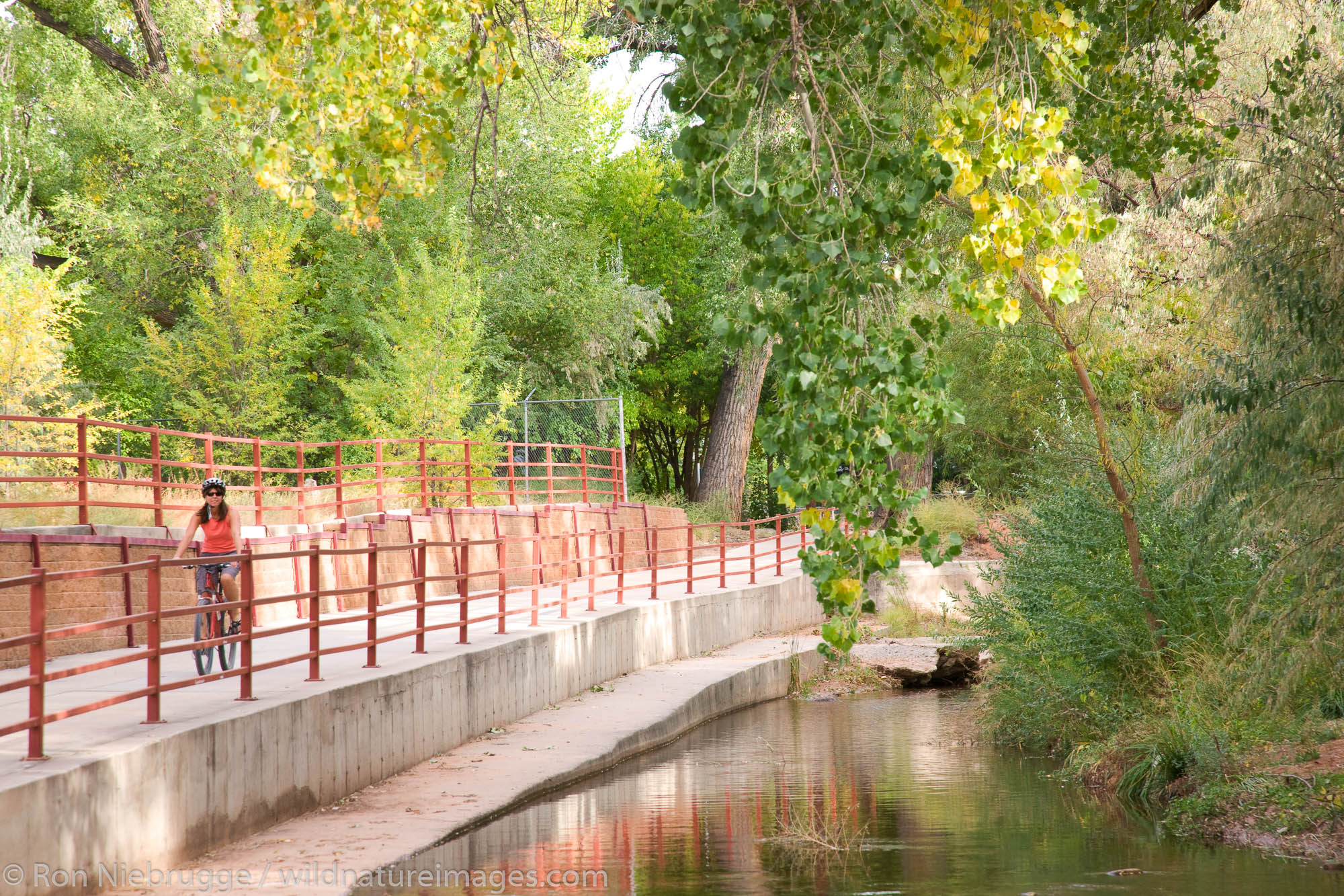 A visitor rides on a bike trail through downtown Moab, Utah.  (model released)