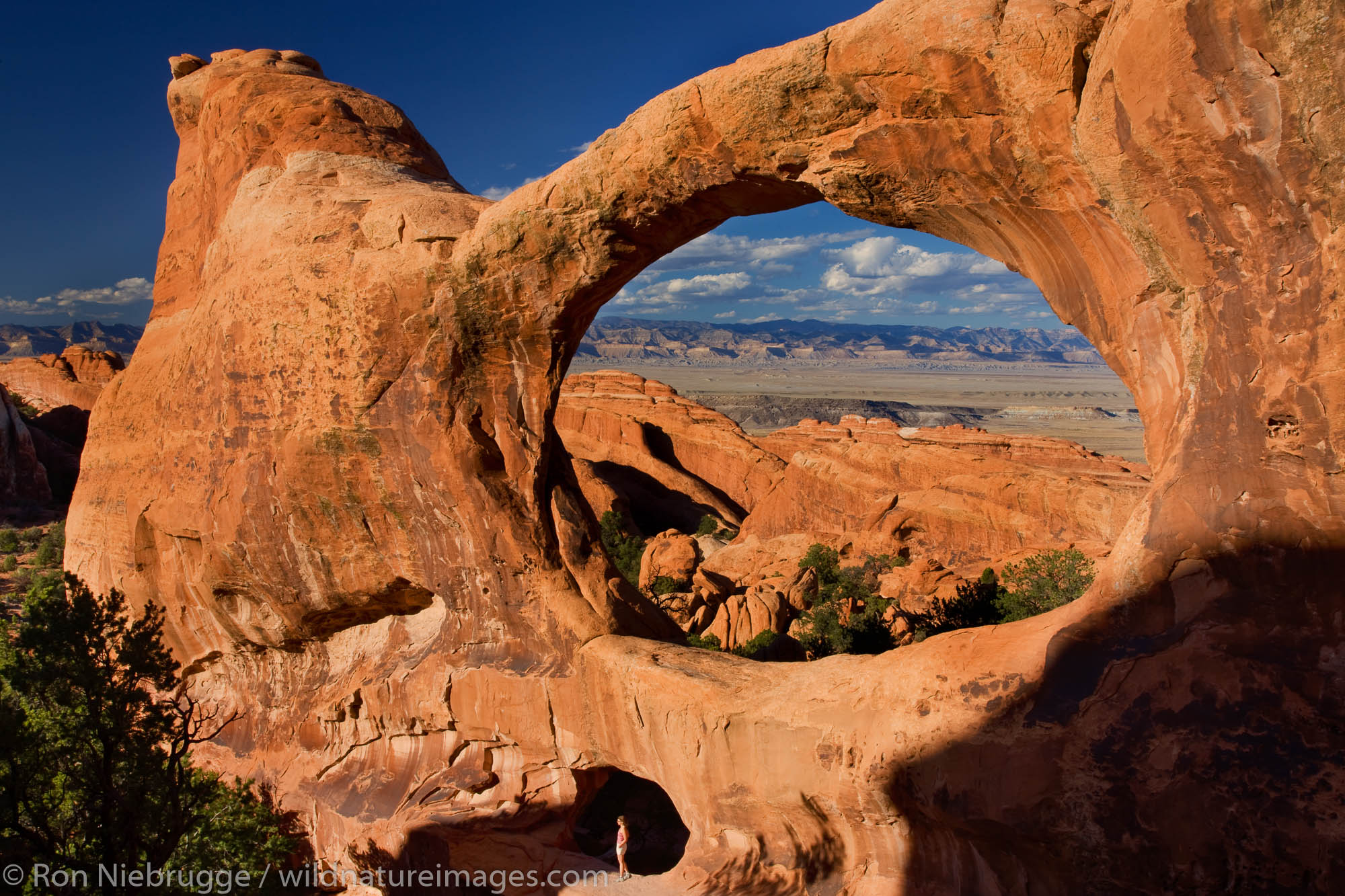 Hiker at Double O Arch, Devils Garden, Arches National Park, Moab, Utah.  (model released)