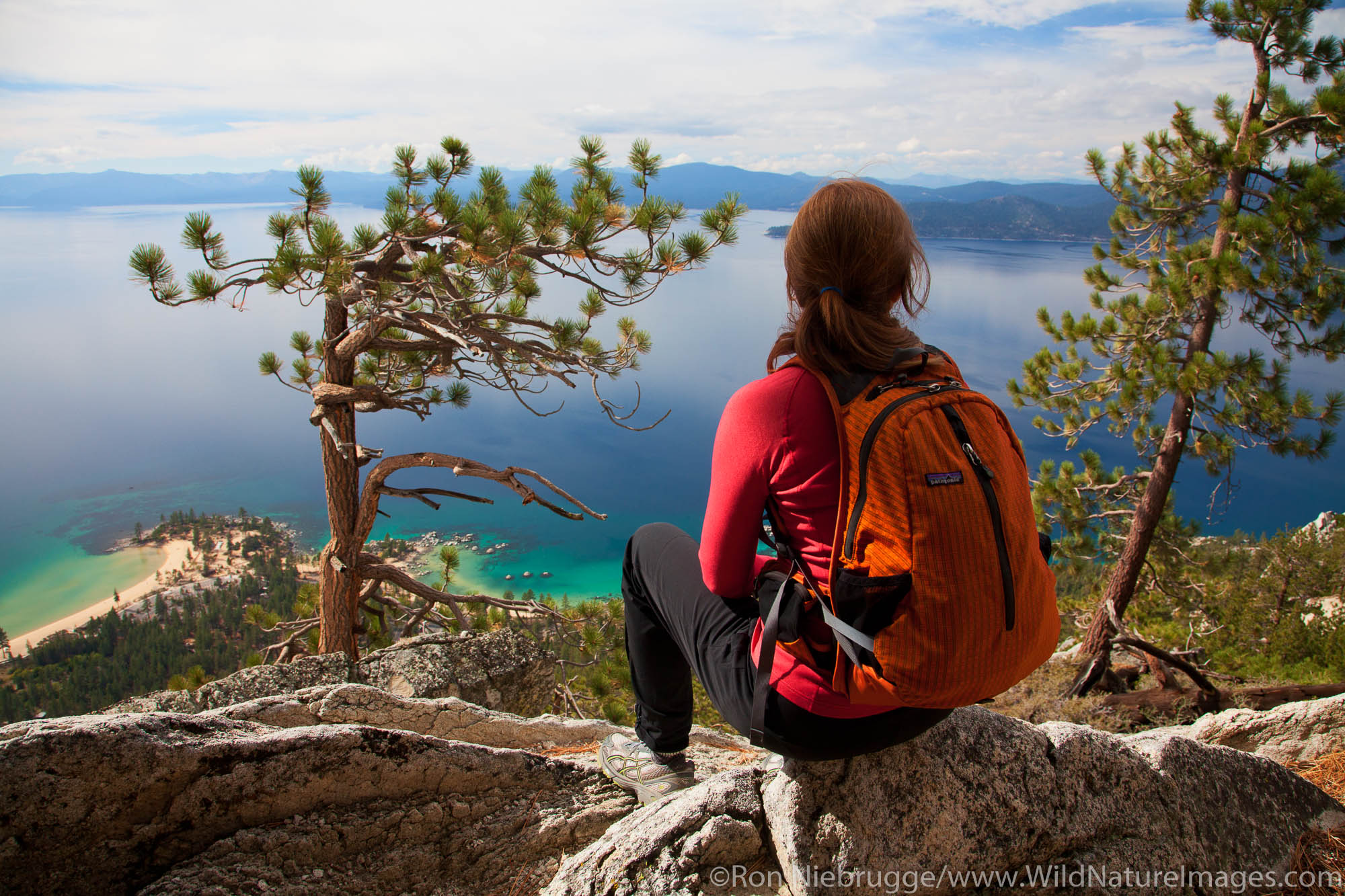 A hiker enjoys the view along the Flume Trail, Lake Tahoe, NV (model released)