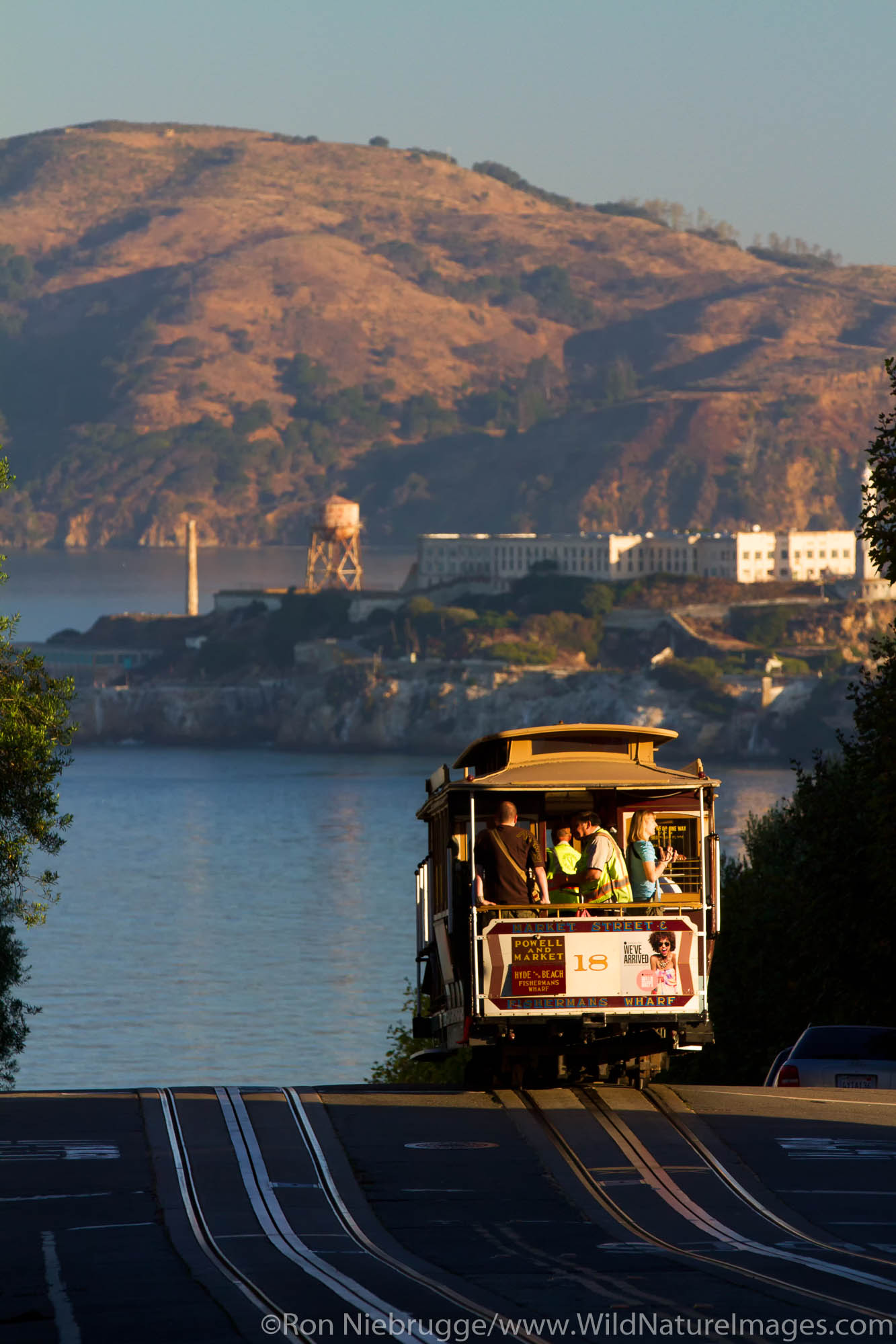 Powell-Hyde cable car with Alcatraz in the distance, San Francisco, CA