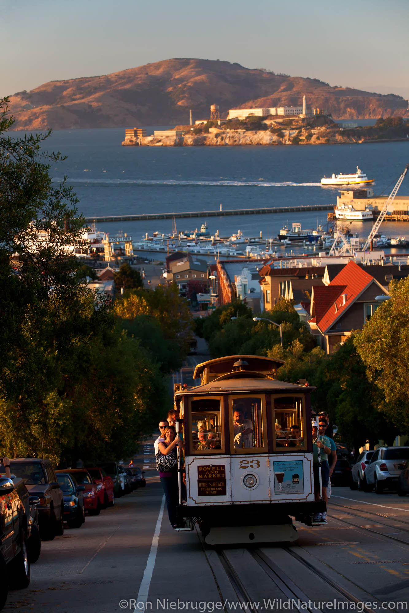 Riding the historic Powell-Hyde cable car, Alcatraz in background, San Francisco, CA