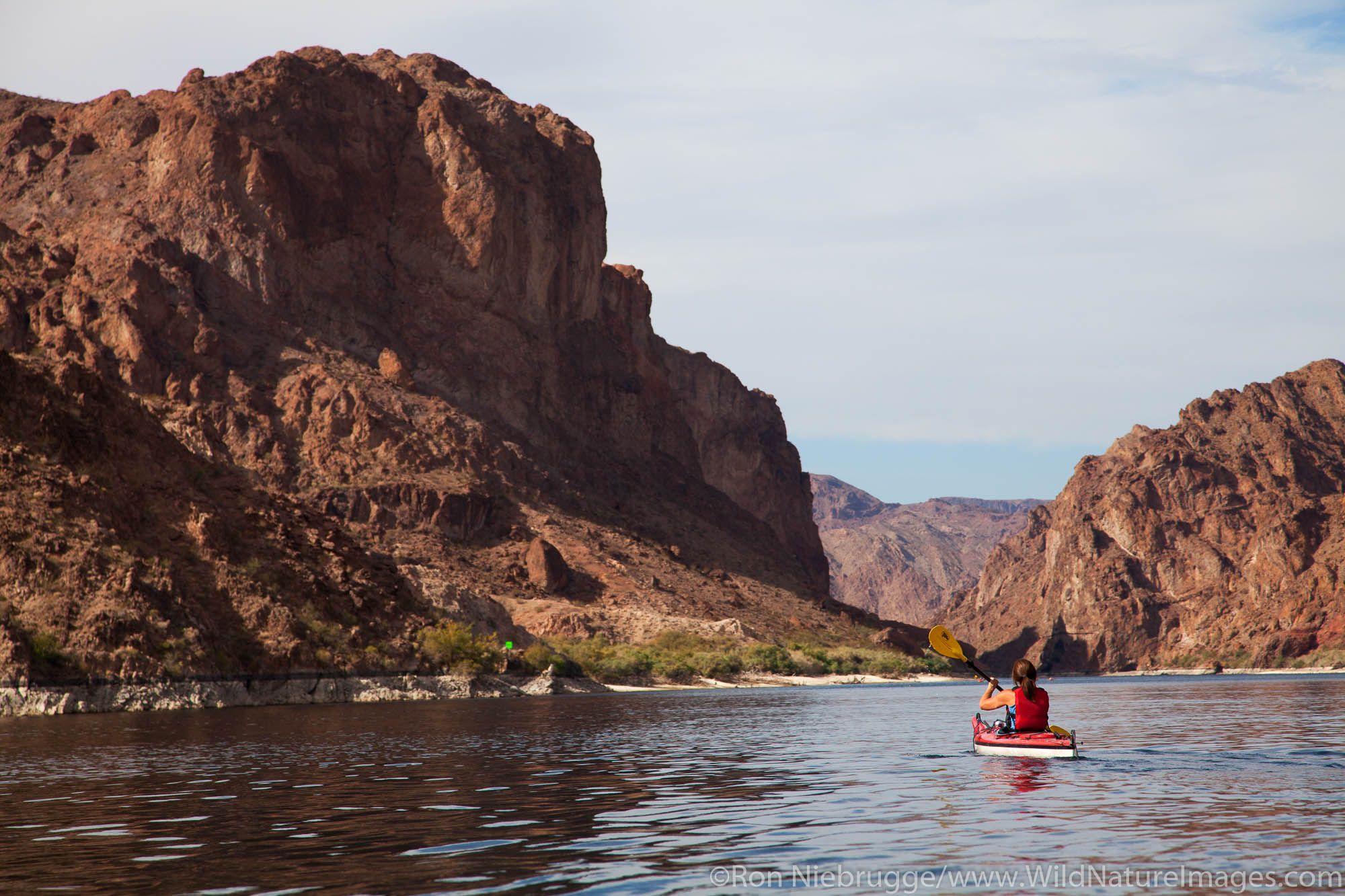 Kayking Black Canyon on the Colorado River, Mojave Desert. (model released)