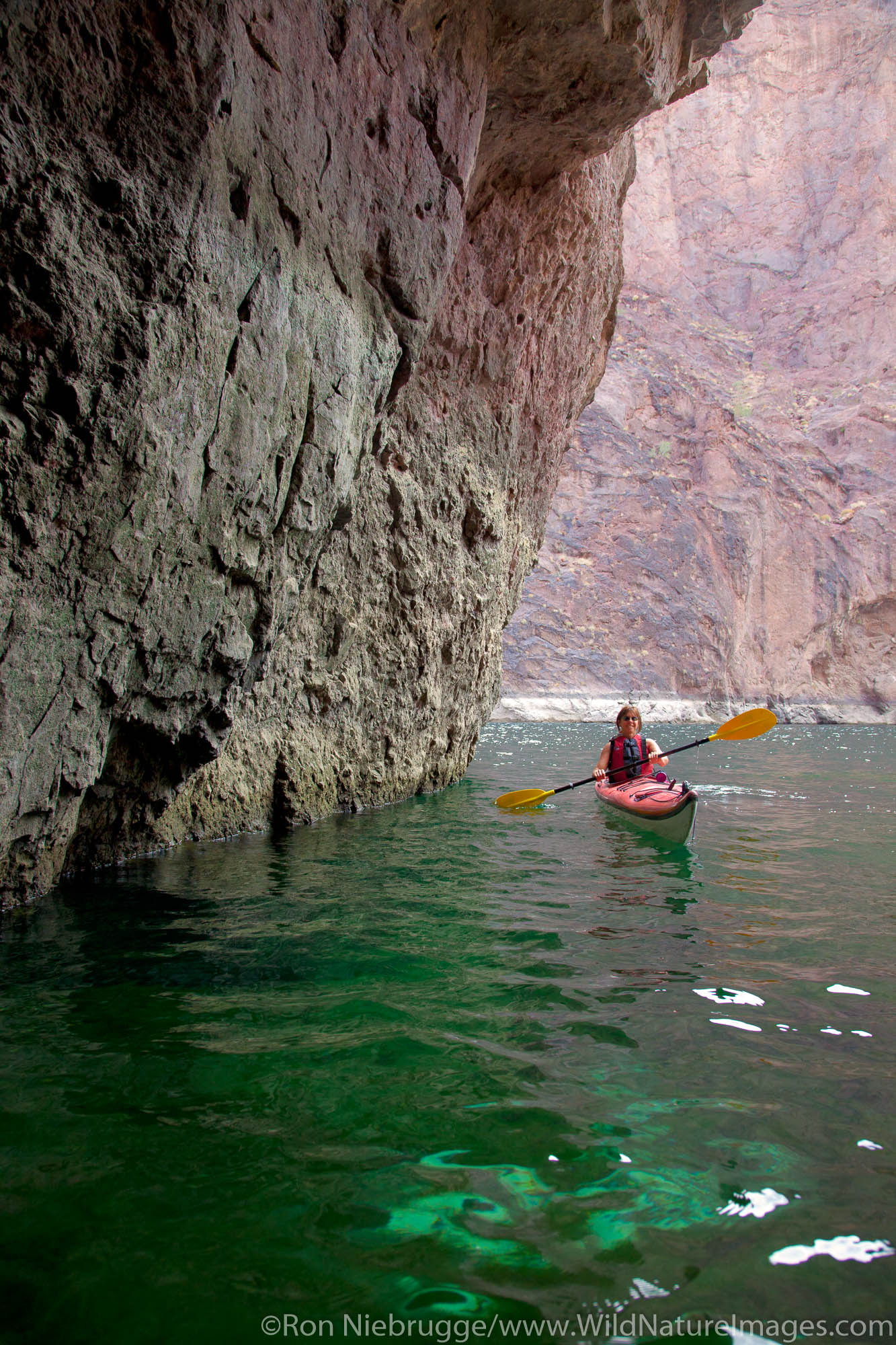 Kayaking in Emerald Cave on the Colorado River, Mojave Desert. (model released)