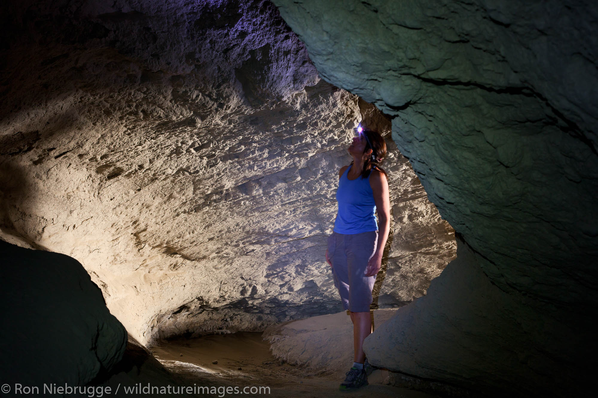 A person exploring some of the biggest mud caves in the world, Anza-Borrego Desert State Park, California.  (Model Released)