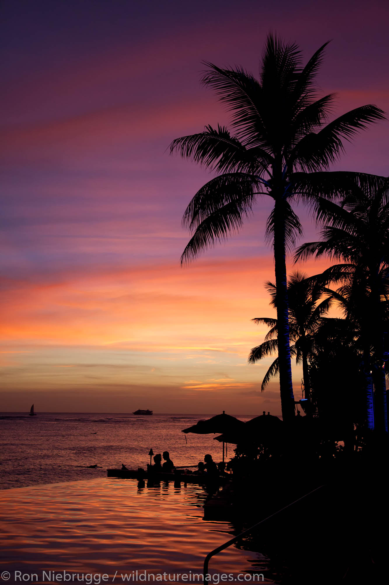 Sunset and the pool at the Sheraton Waikiki, Waikiki Beach, Honolulu, Hawaii.