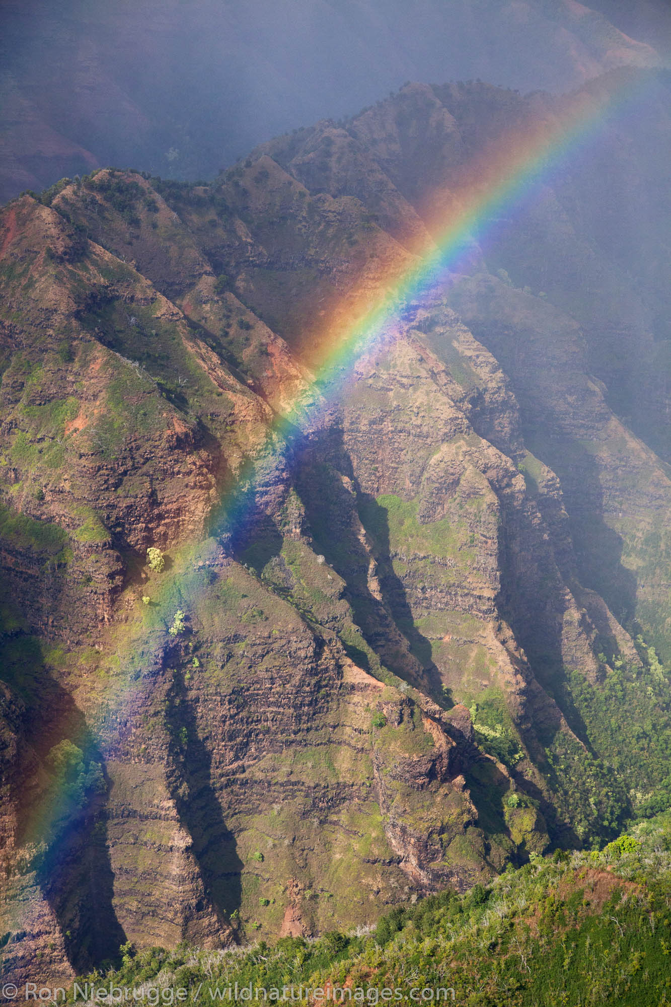Aerial of a rainbow over Waimea Canyon, Kauai, Hawaii.