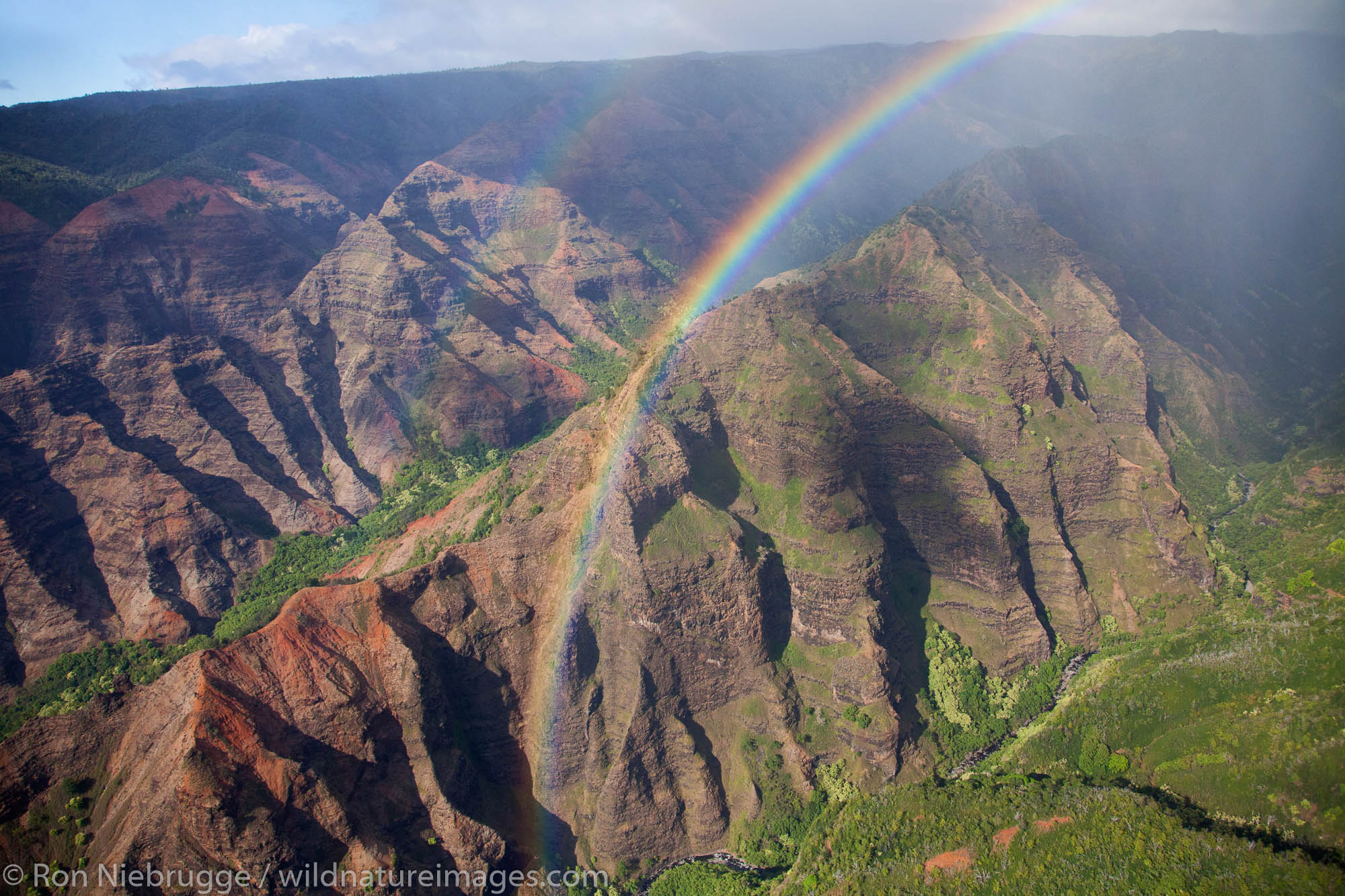 Aerial of a rainbow over Waimea Canyon, Kauai, Hawaii.
