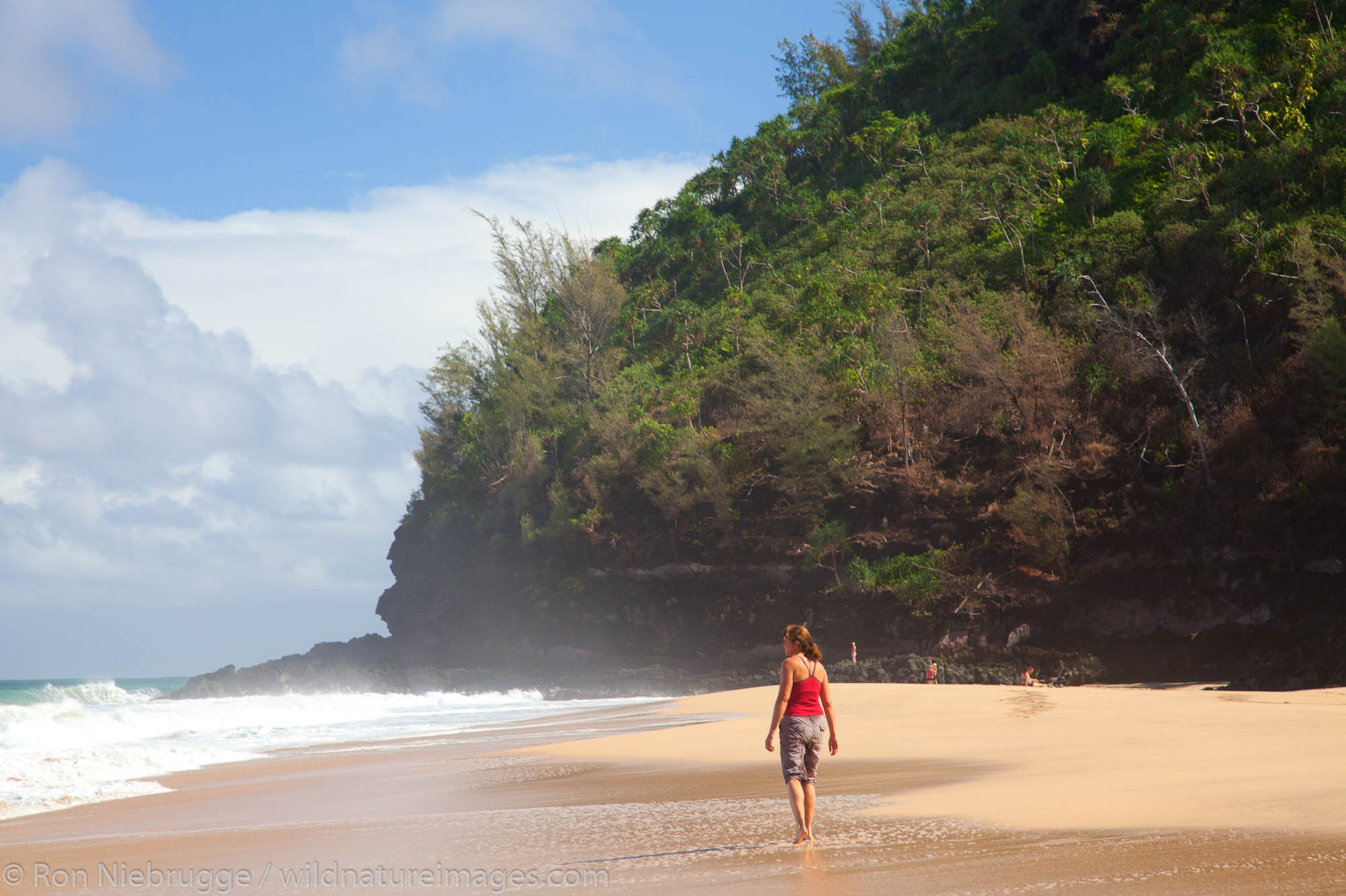 Hiker at Hanakapi'ai Beach along the Kalalau Trail, Na Pali Coast, Kauai, Hawaii.  (Model Released)