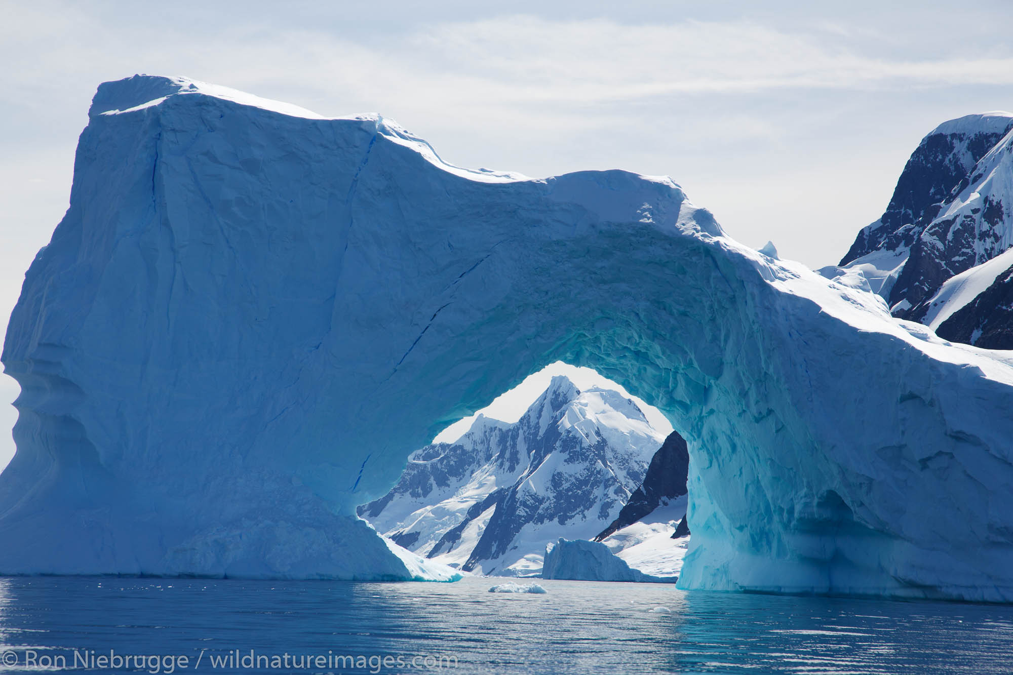 Giant arch in an iceberg, Petermann Island, Antarctica.