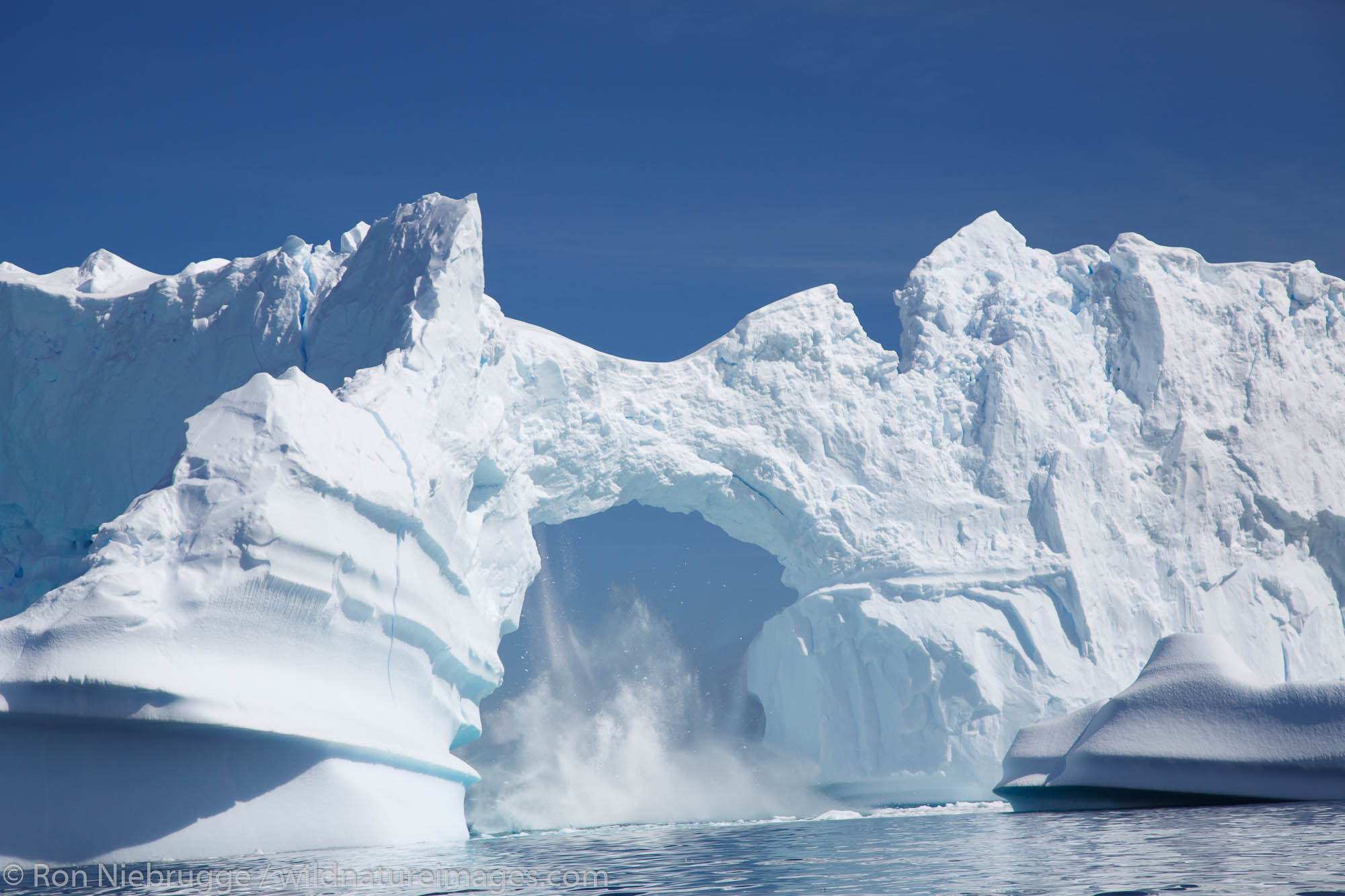 Giant arch in an iceberg, Petermann Island, Antarctica.