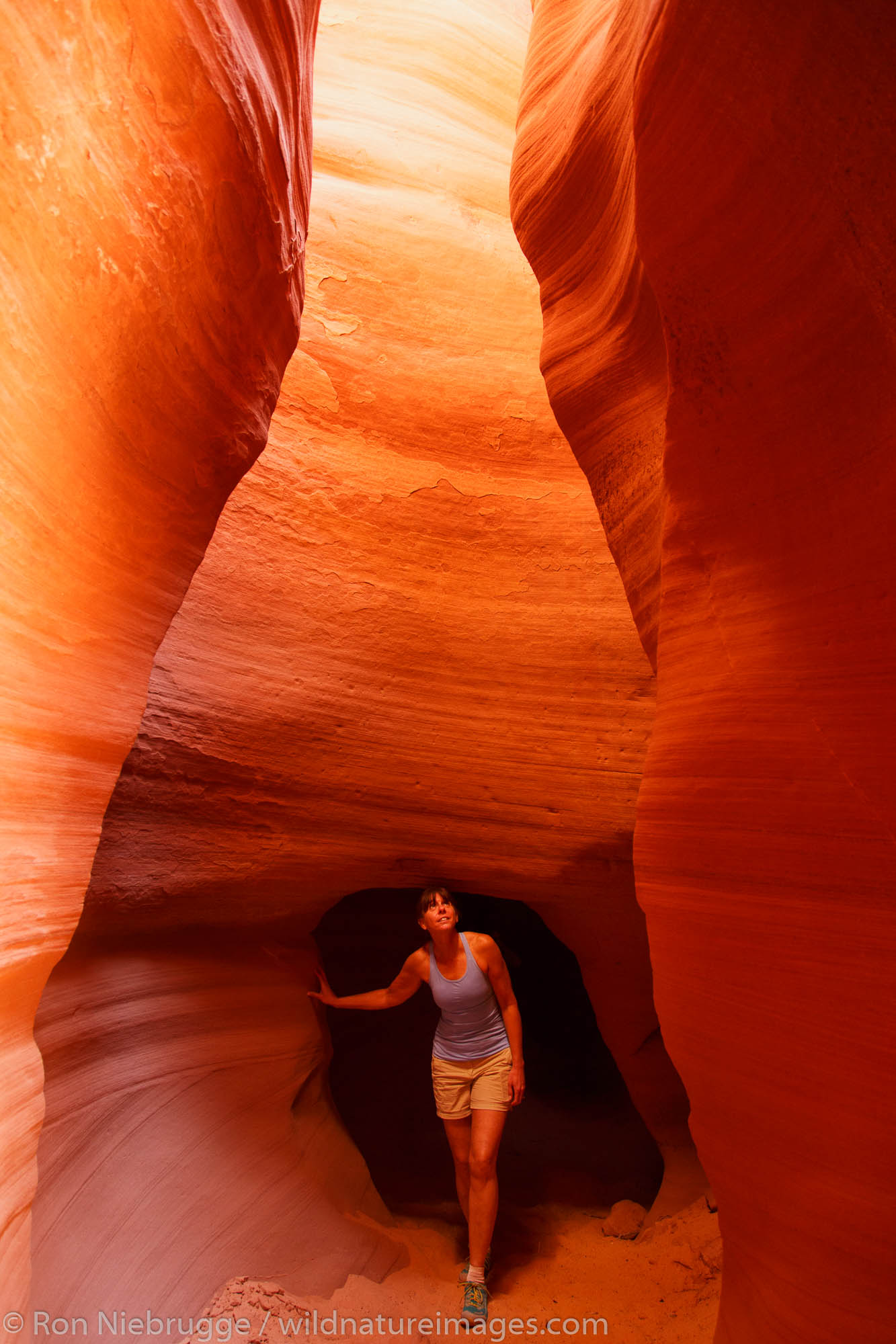A visitor in Canyon X slot canyon, Page, Arizona. (model released)