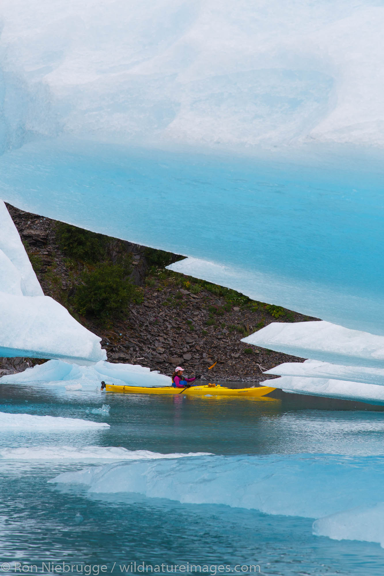 Kayaking in Bear Glacier Lagoon, Kenai Fjords National Park, near Seward, Alaska.  (model released)