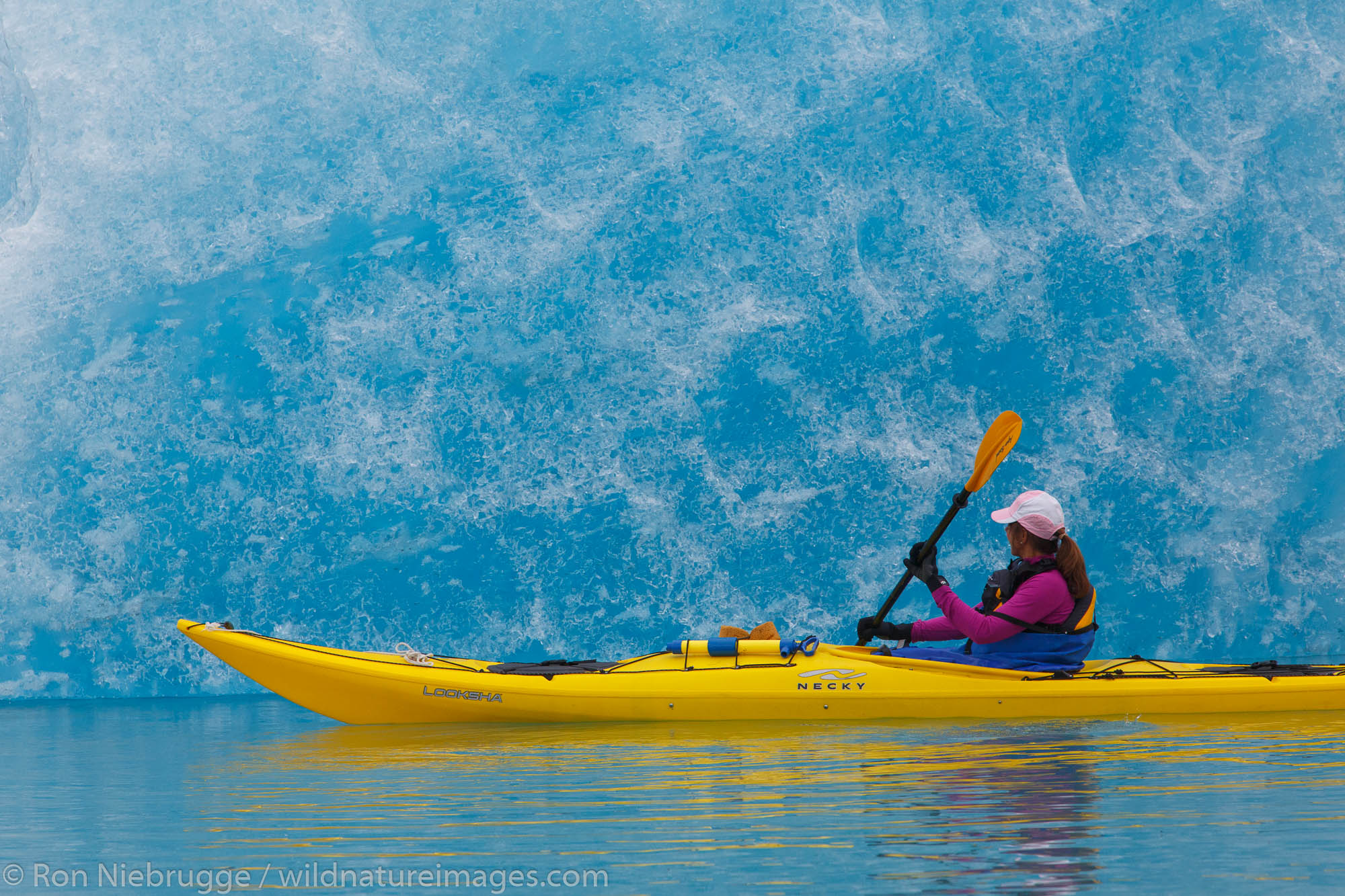 Kayaking in Bear Glacier Lagoon, Kenai Fjords National Park, near Seward, Alaska.  (model released)